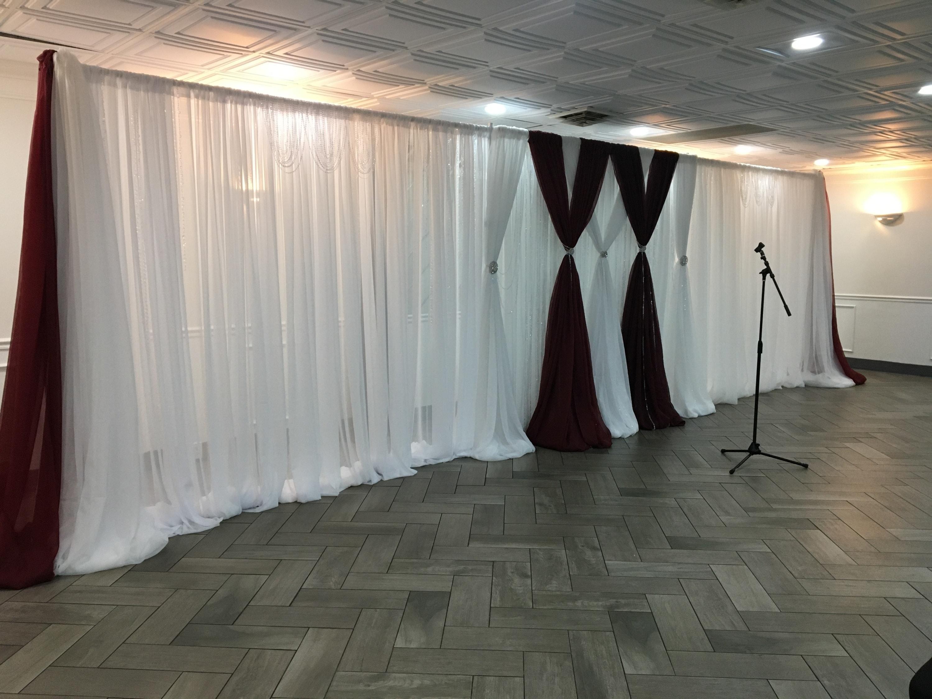 This Gorgeous Burgundy & White 44ft long at 8ft high Backdrop can be set up at your event celebration, in your color theme.