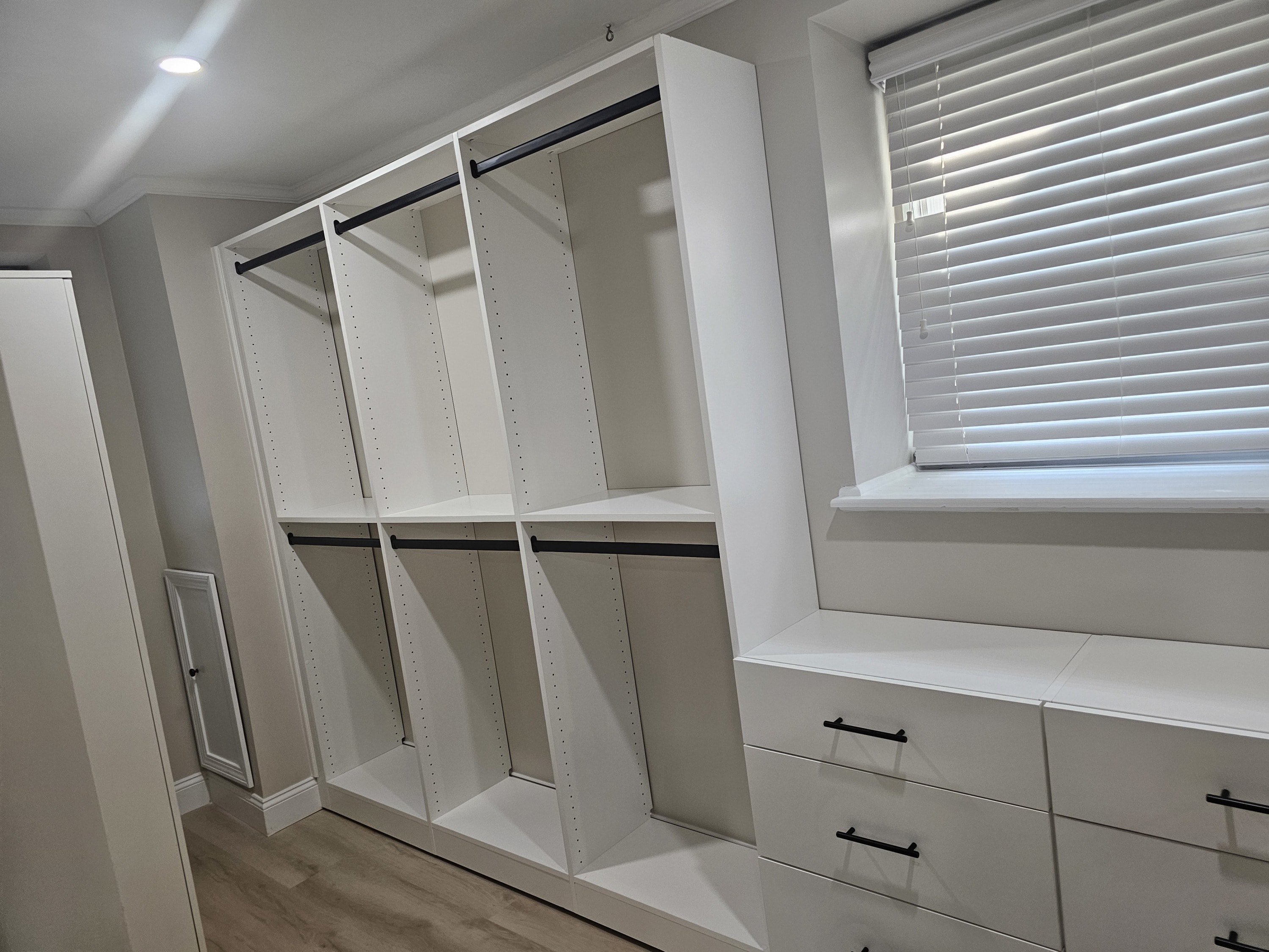 White melamine walk in closet with black accessories