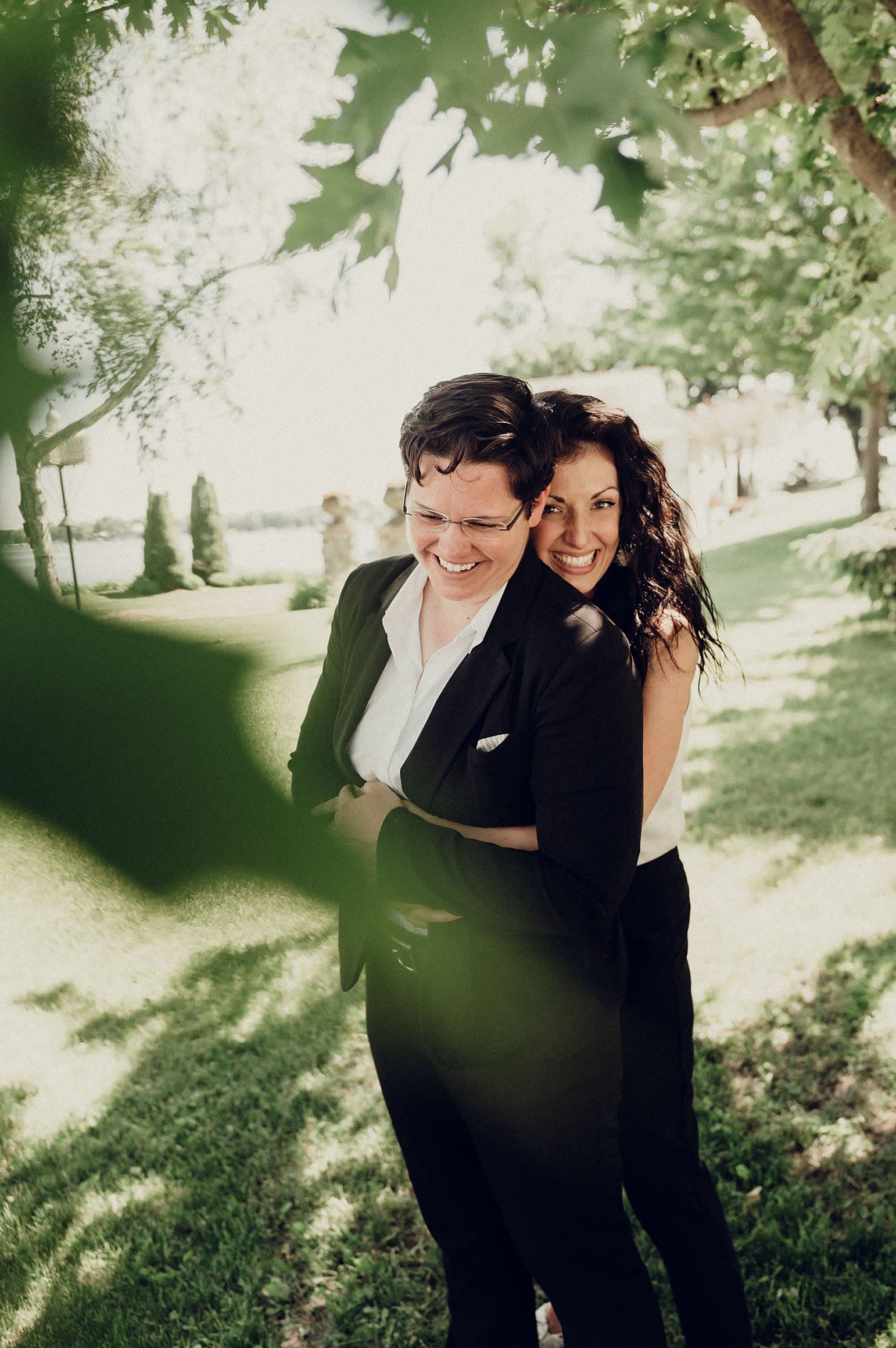 Two brides enjoy a wedding hug together