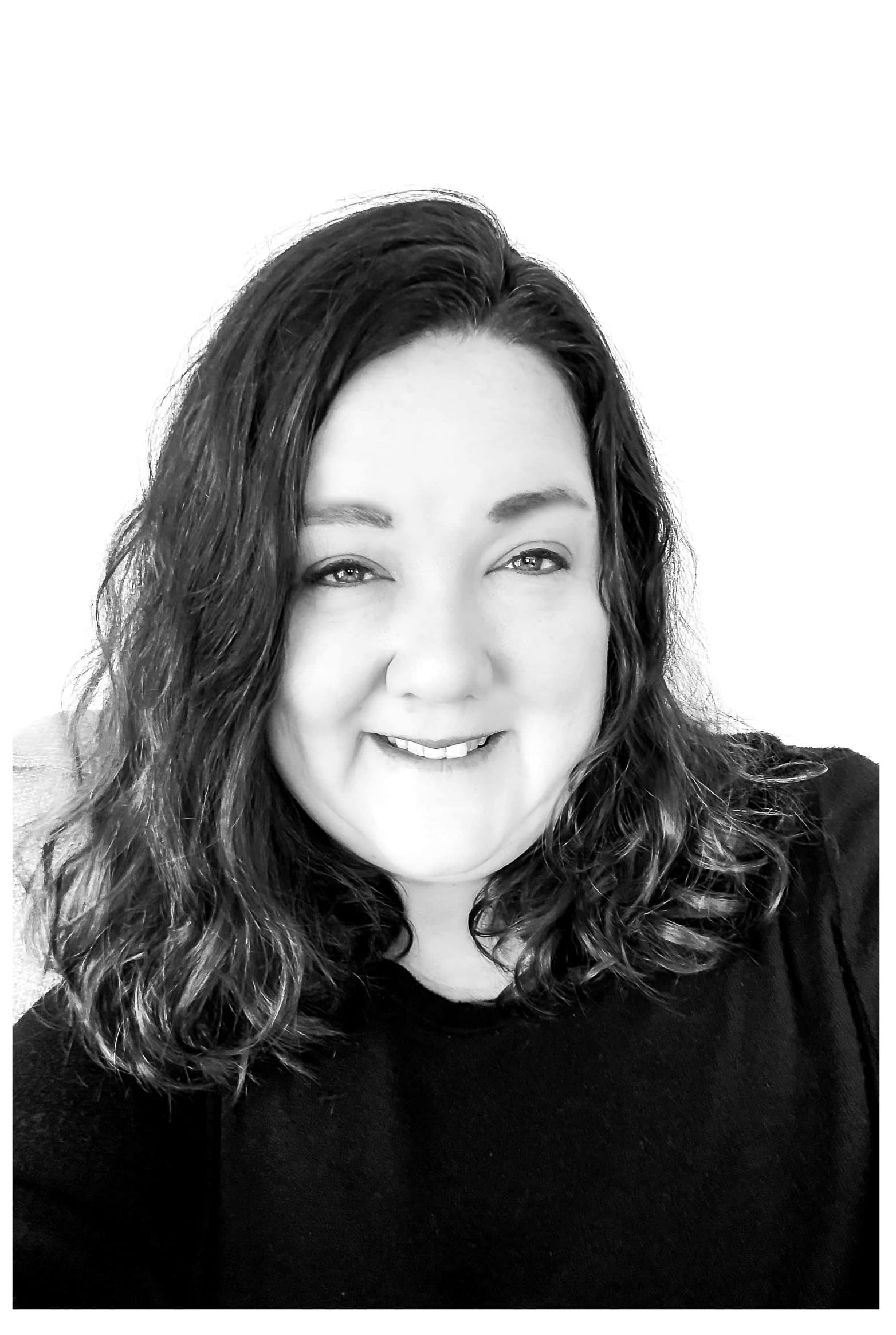 portrait of a professional family and newborn photographer smiling.