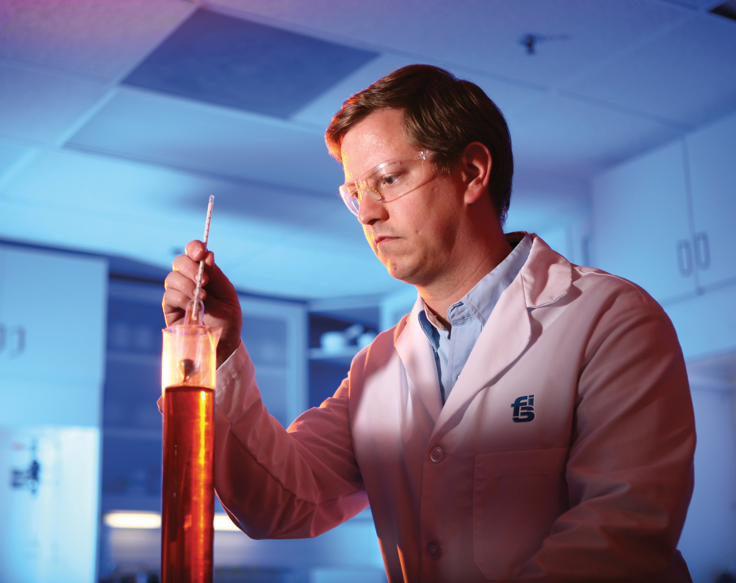 Chemist testing polyurethane foam in a laboratory to evaluate formulation performance and material quality.