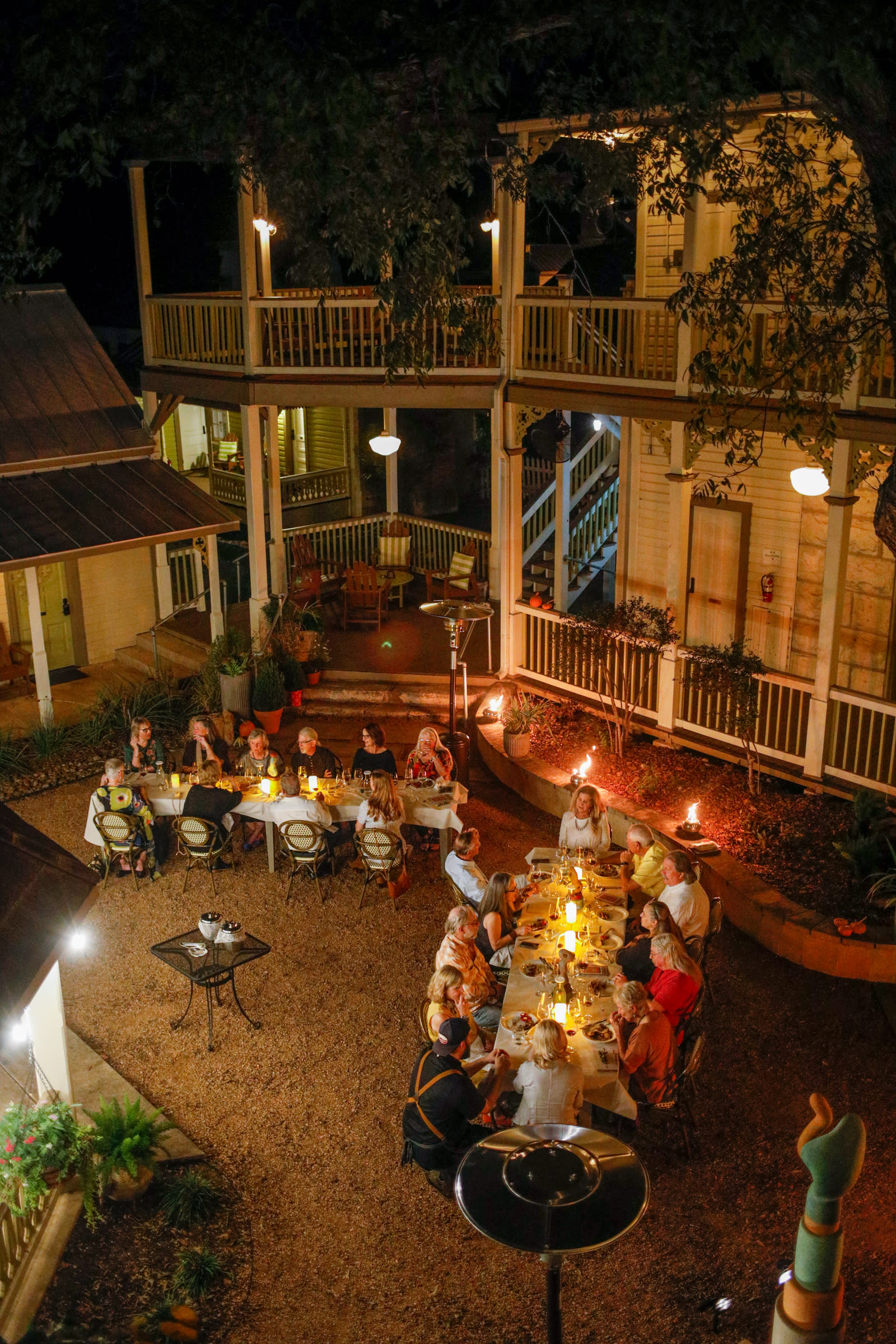 group of people having meal in outdoor courtyard