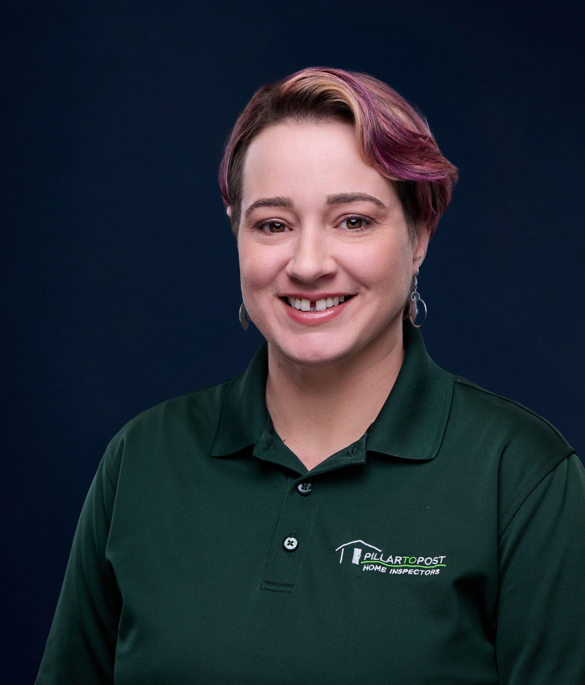 Headshot of Norita Cruz wearing a green polo shirt with her business logo with text "Pillar to Post Home Inspectors"