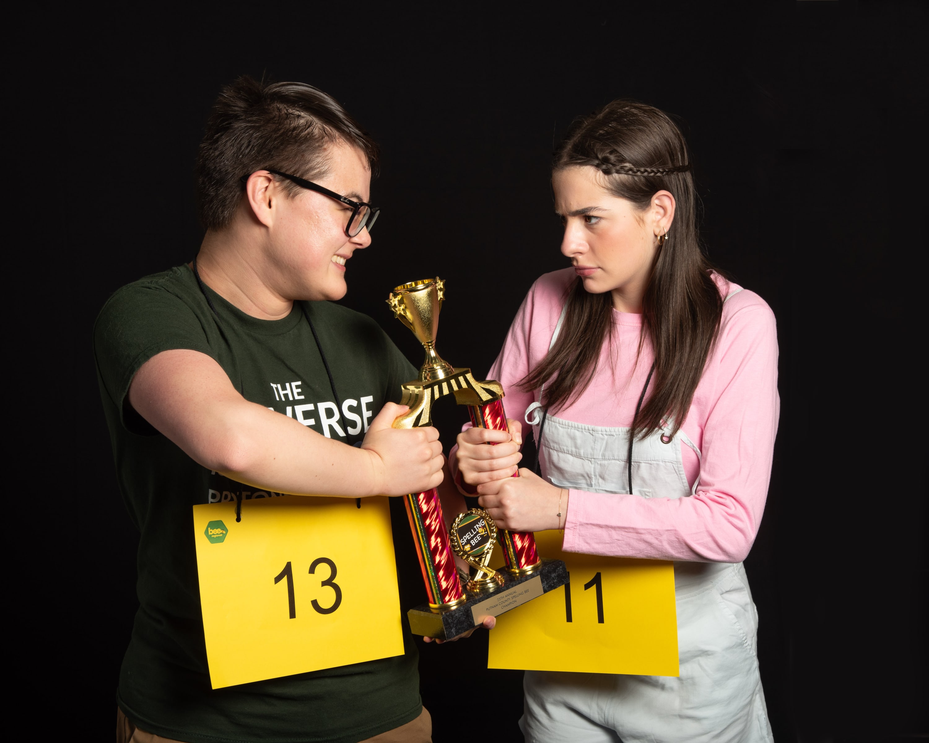 William Barfee and Olive Ostrovsky, two participants in the bee, stand together each holding the trophy for the bee. They hav