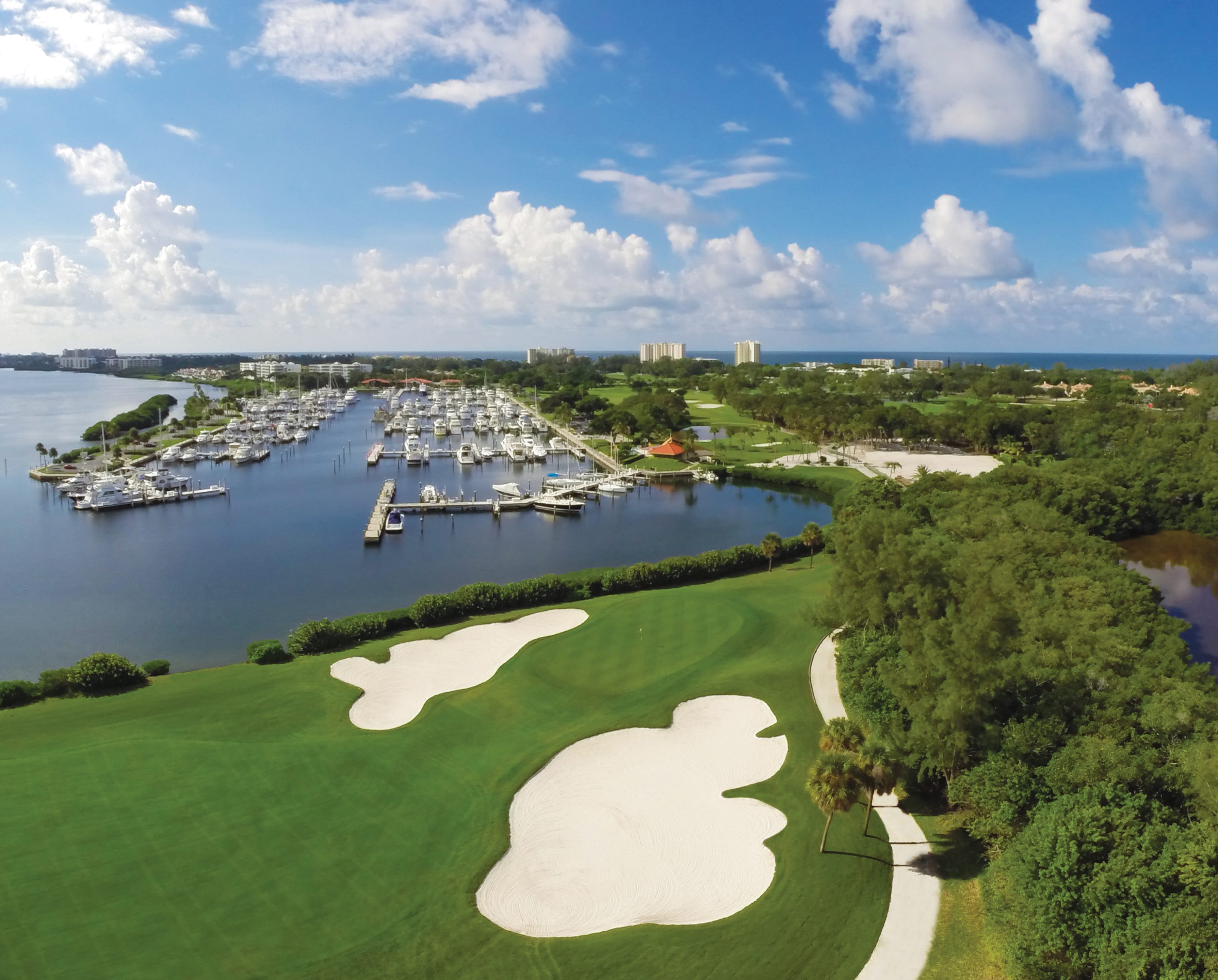Golf course with two sand traps in foreground with Marina in background