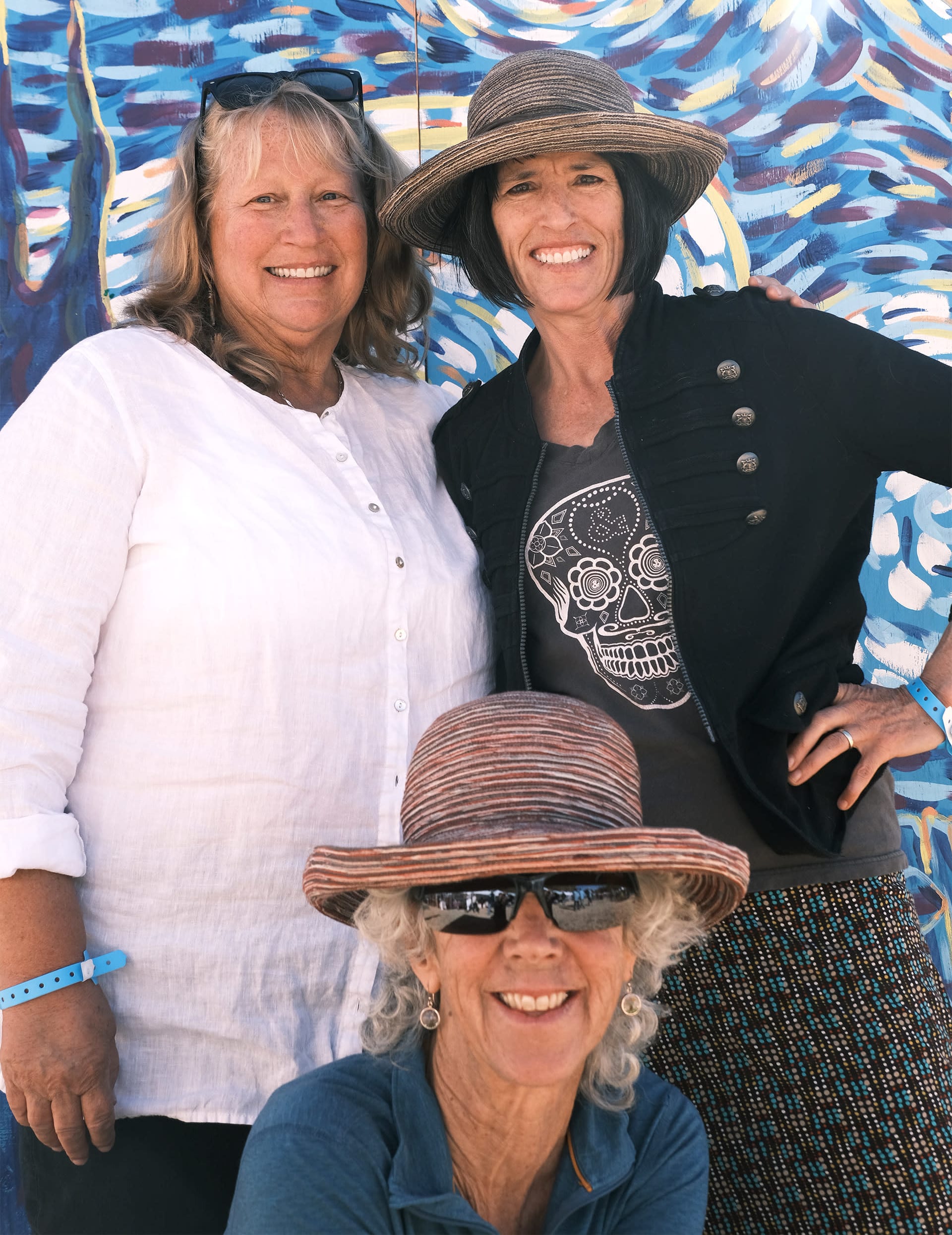 Three women posing together for a photo.