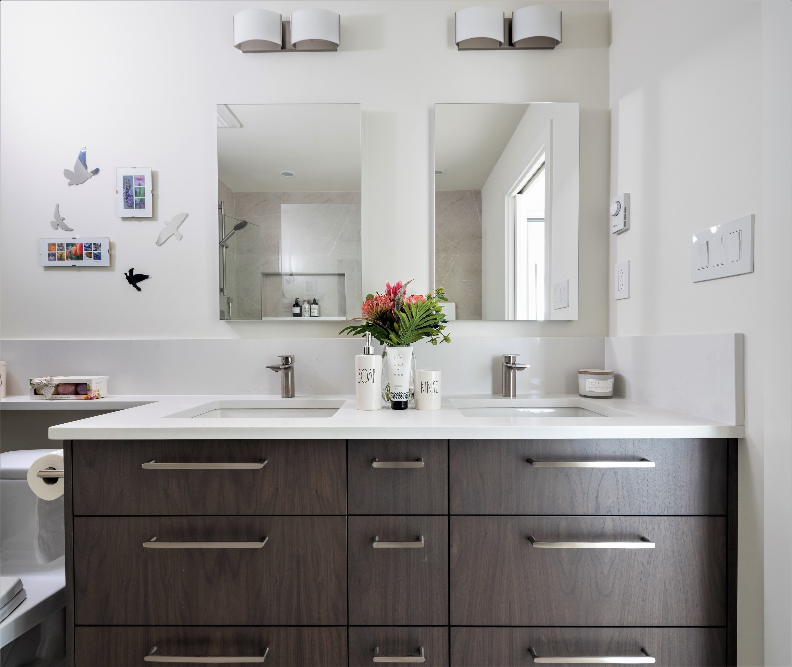 double-sink-dark-oak-custom-cabinets-white-countertop-stainless-steel-plumbing-fixtures