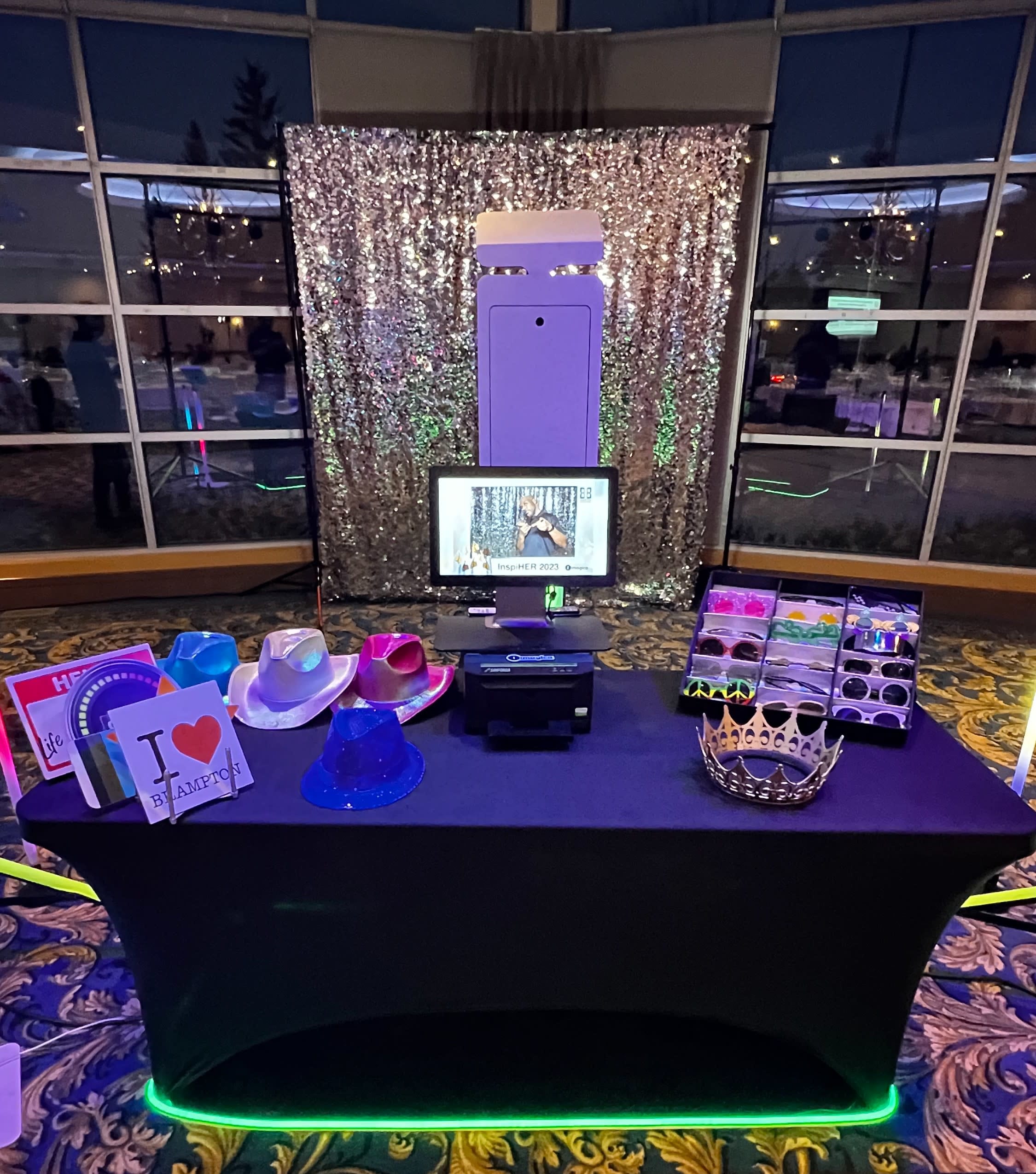 Photo booth setup with backdrop and props