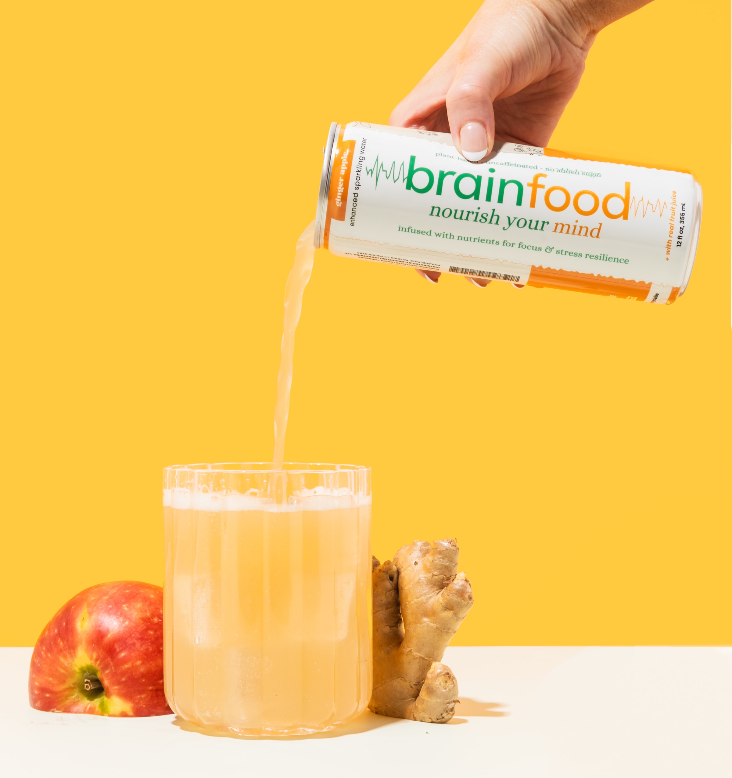 Brainfood sparkling water being poured into a glass — caffeine-free functional drink made with real fruit and nutrients for f