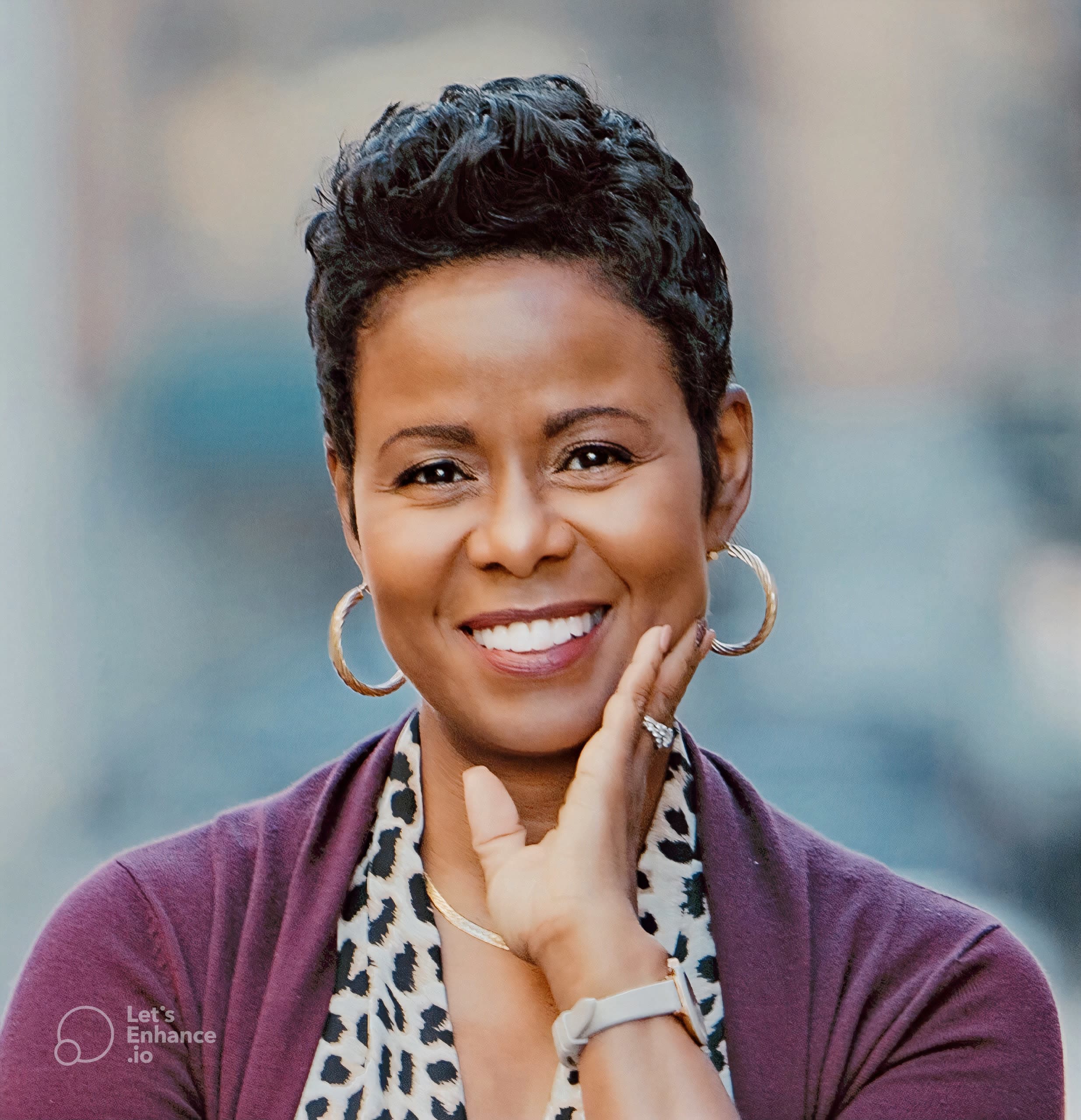 Woman with short hair cut, dark red sweater and animal print shirt
