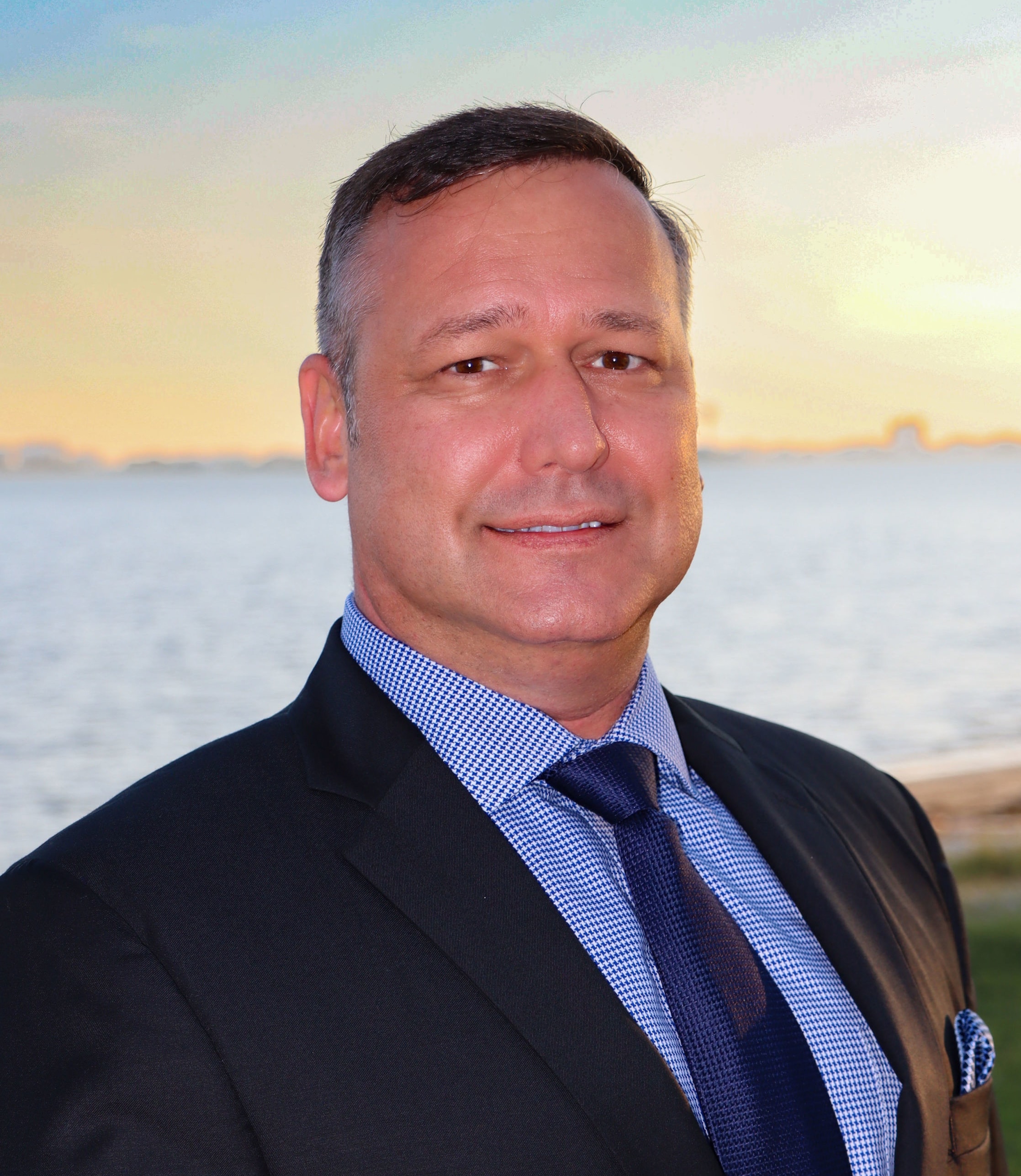 Timothy Bates in formal attire, posed confidently for Chamber of Commerce profile