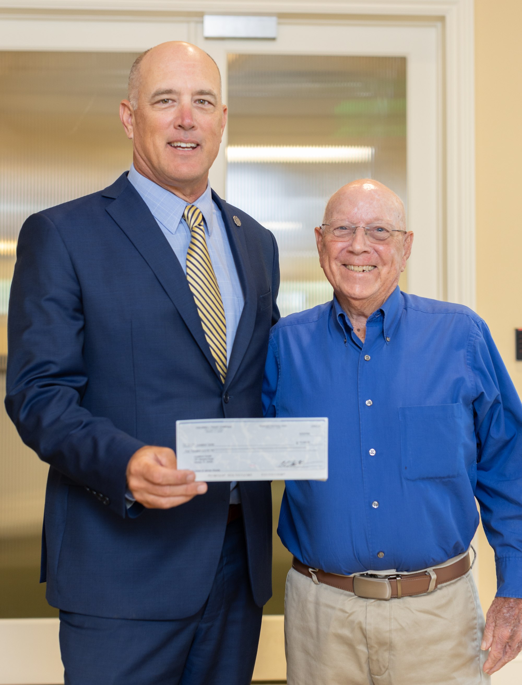 Jim Woods honored with $5,000 donation to Loveland Center for 20 years of board service.