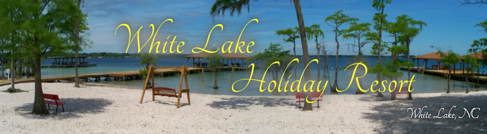 View of White Lake NC with Sandy Beach, Cypress Trees, Piers, and Benches