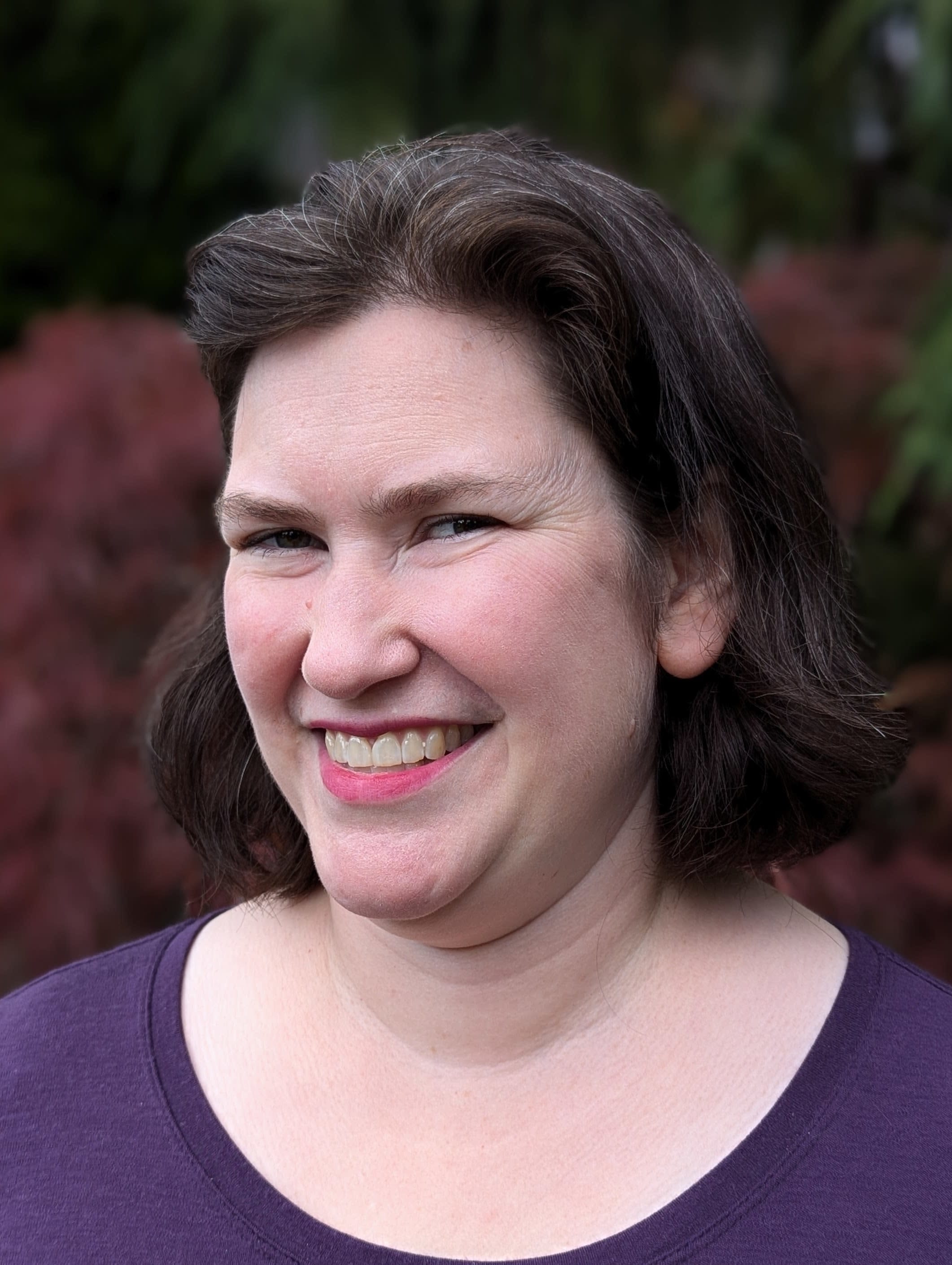 image of Z Johnson dressed in a purple top against a dark outdoor background