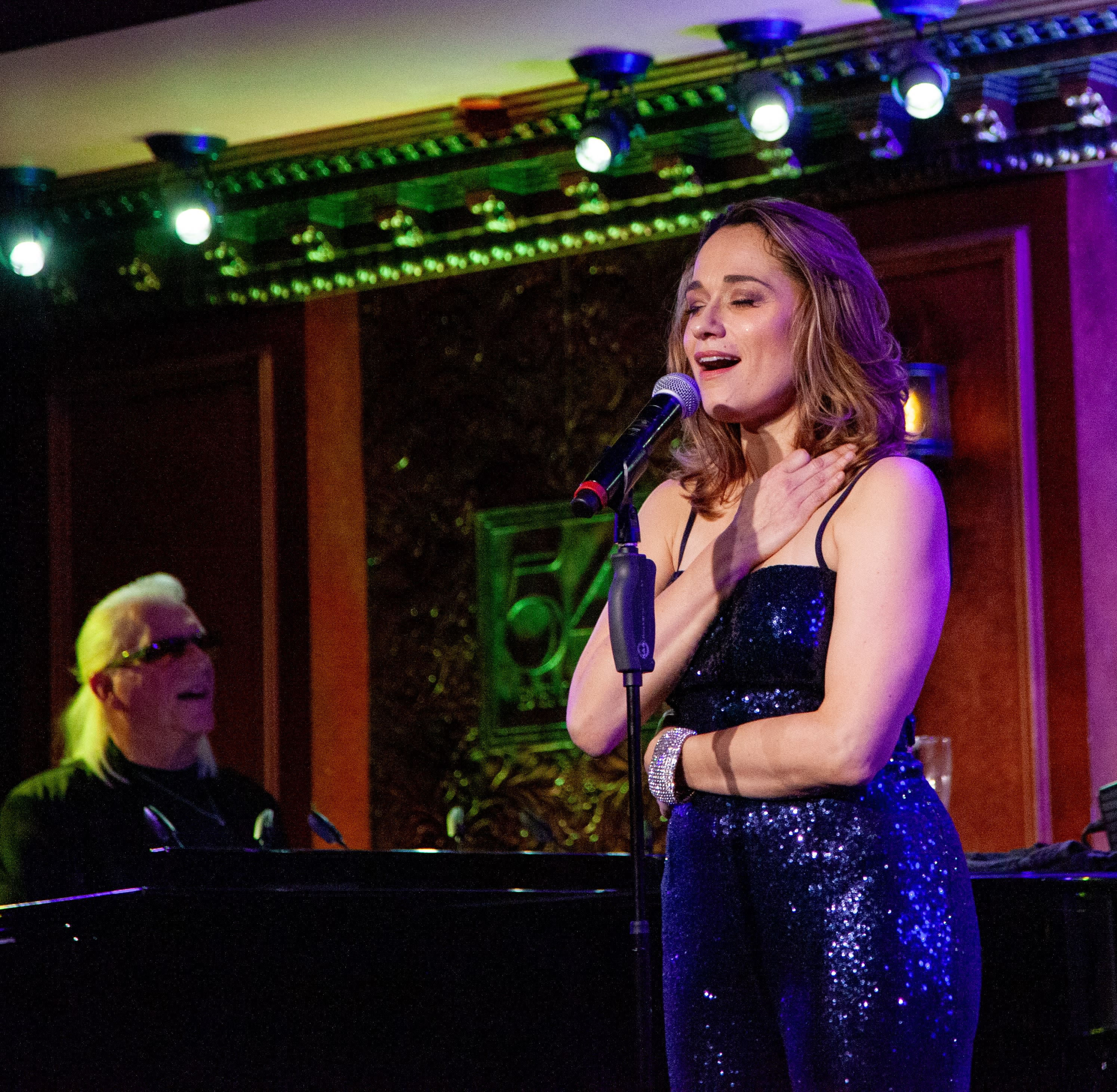 Lianne Marie Dobbs in performance at 54Below in New York City, with Ron Abel at the piano, closing their eyes to take