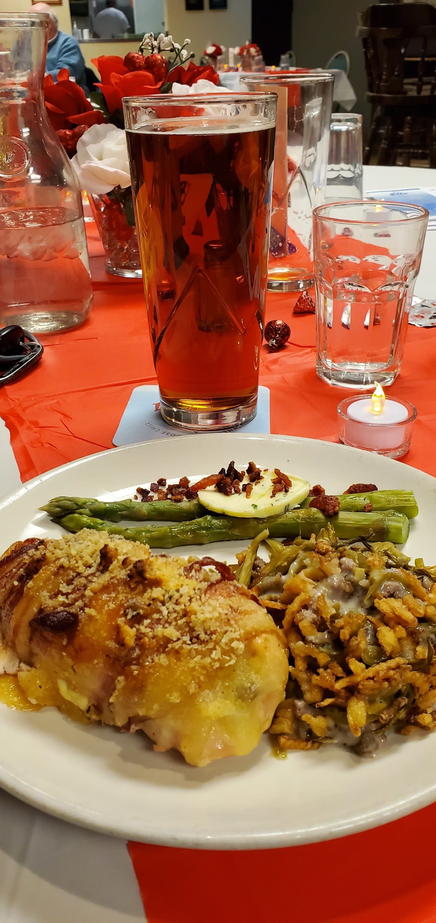 Bacon wrapped chicken breast with asparagus on a festive Valentine's place setting.