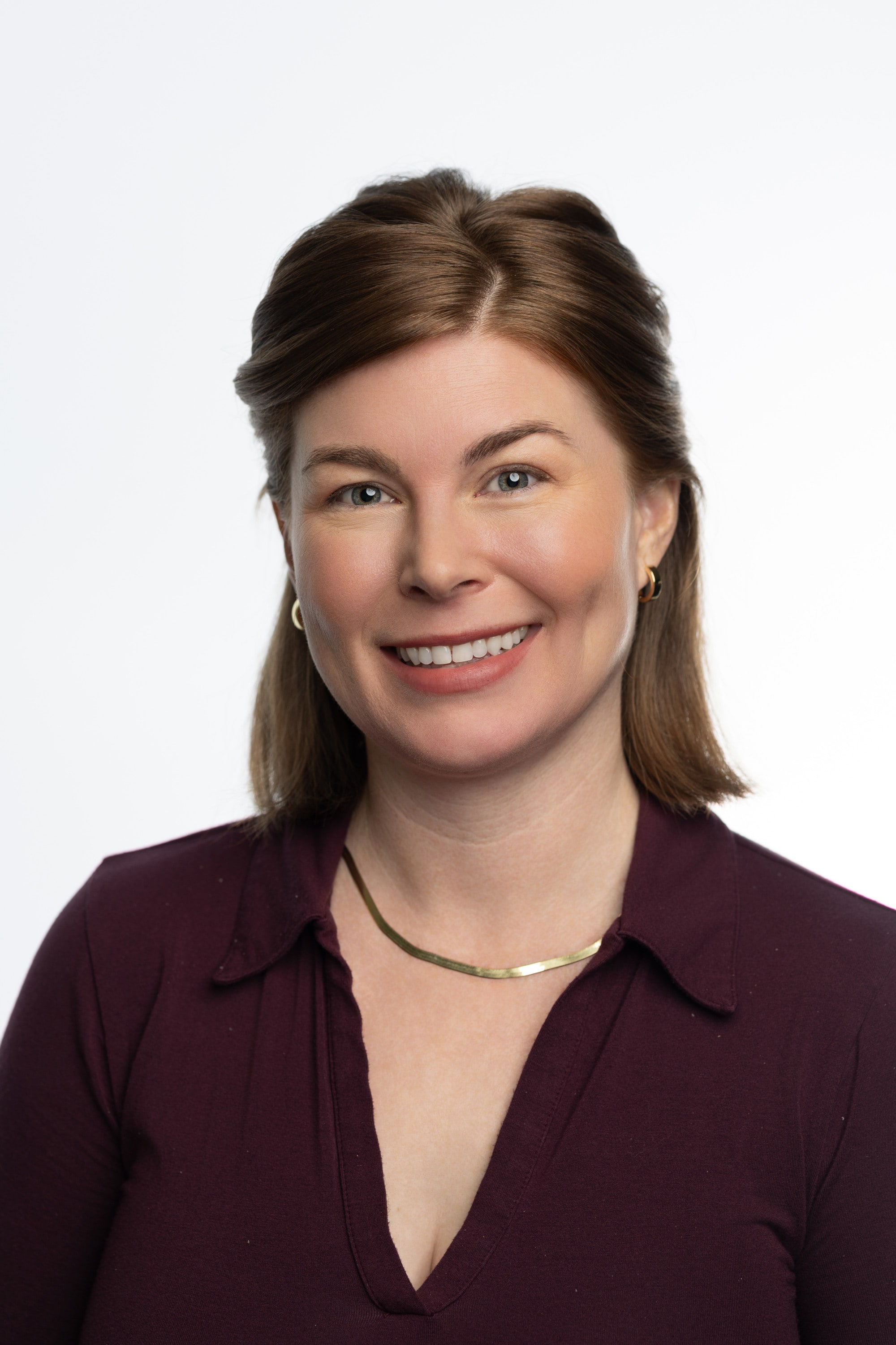 Lauren smiles into the camera in a professional headshot