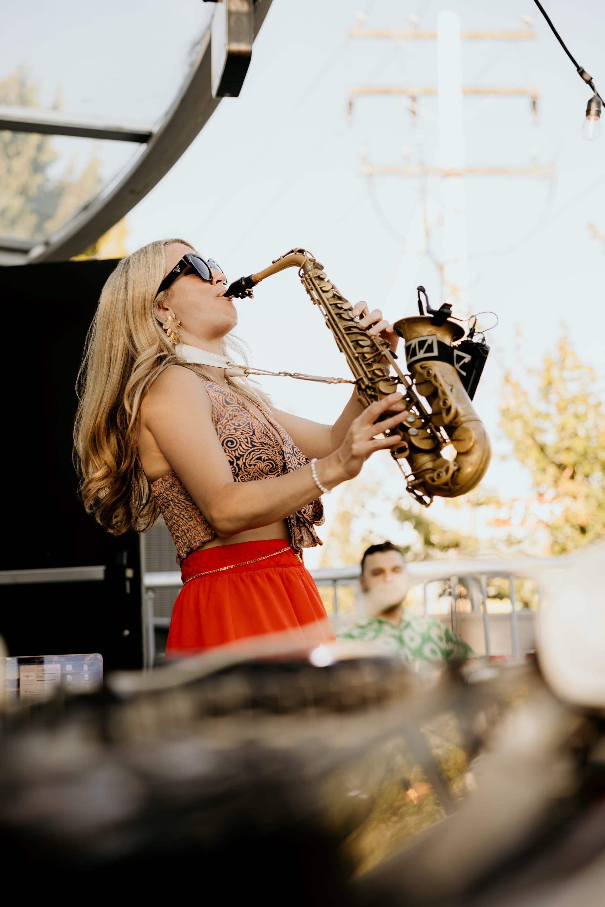 Karla on the saxophone playing at Nook Coworking Space Richmond's patio tech event