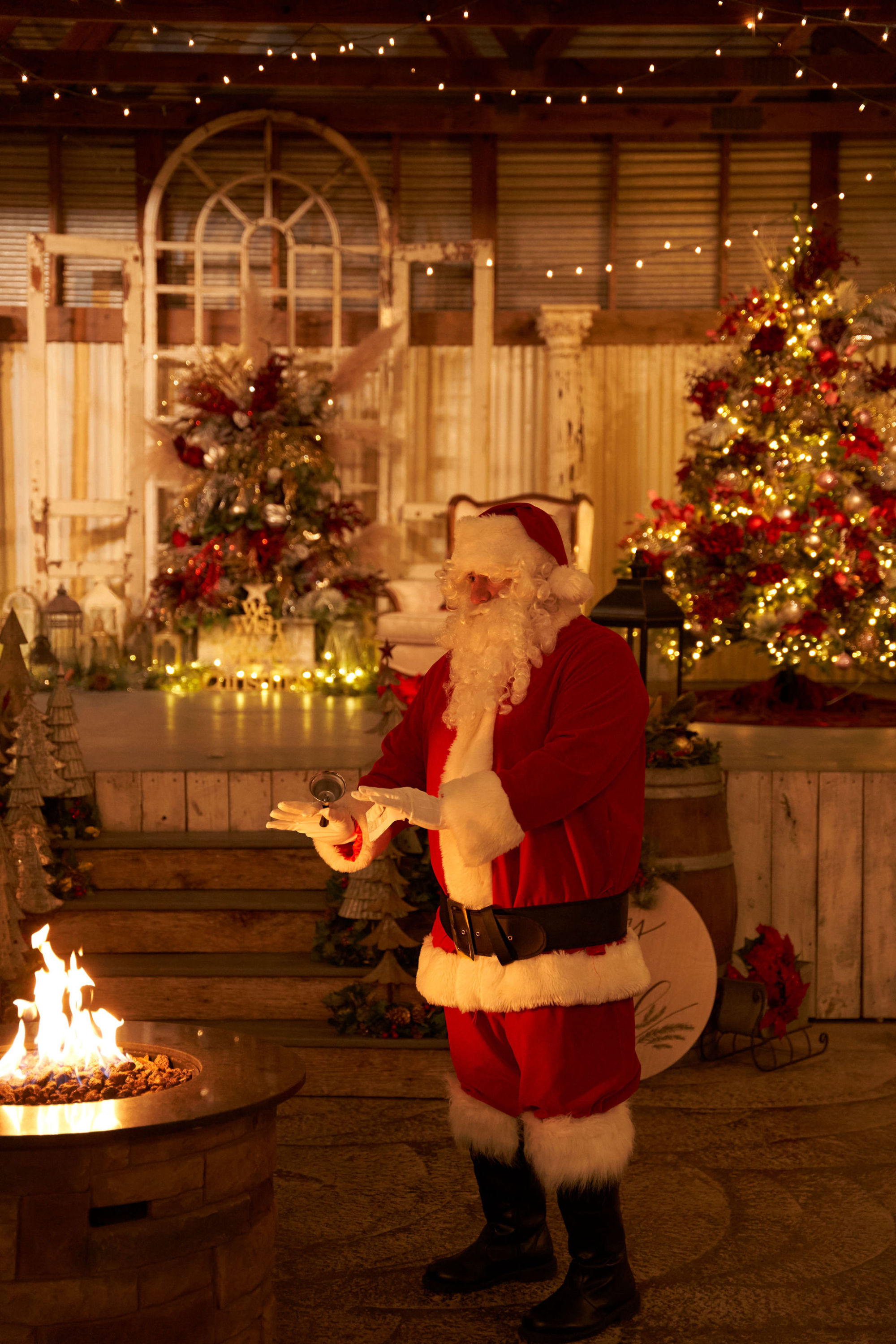 Santa warming hands by the fire