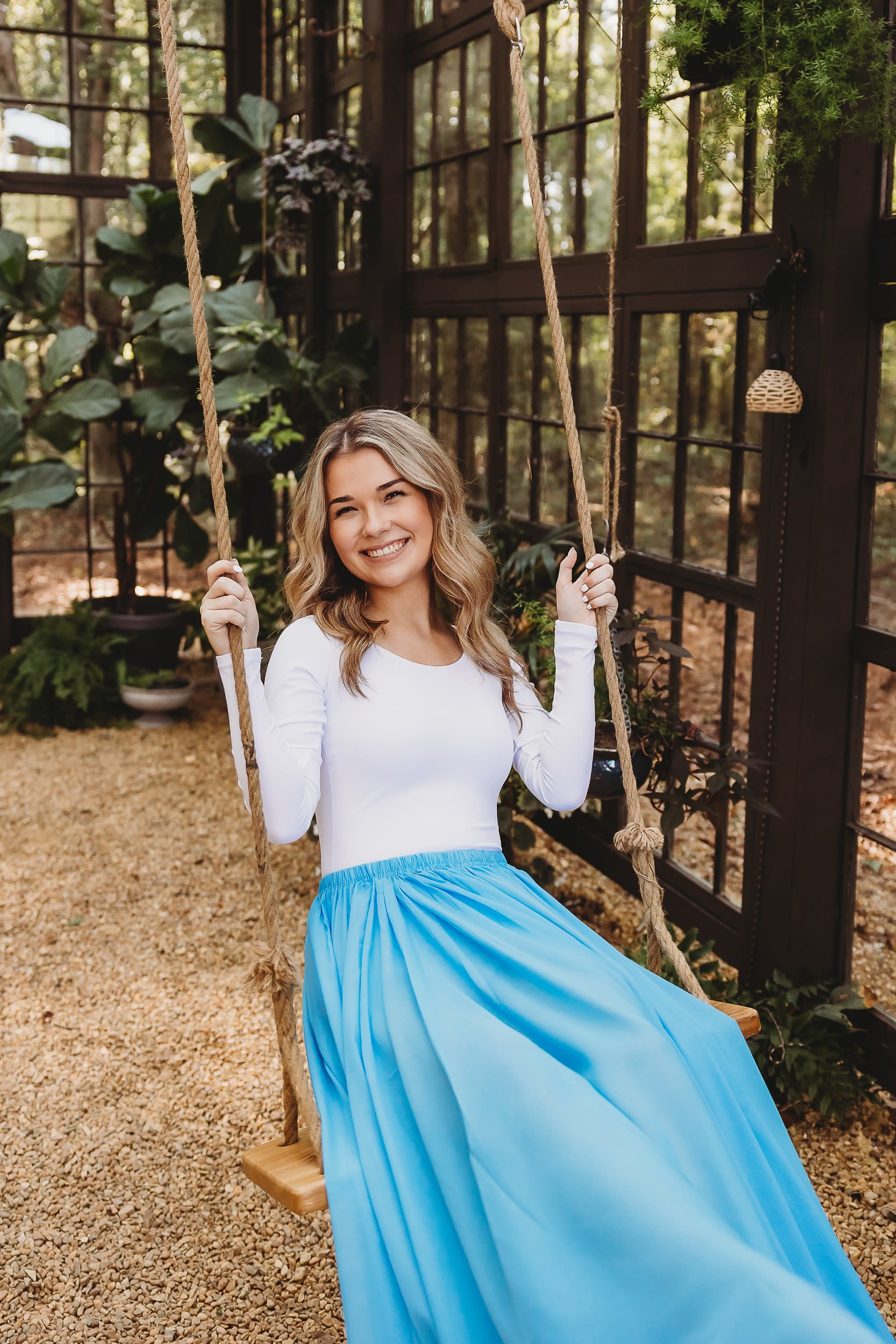 senior girl greenhouse swing blue dress