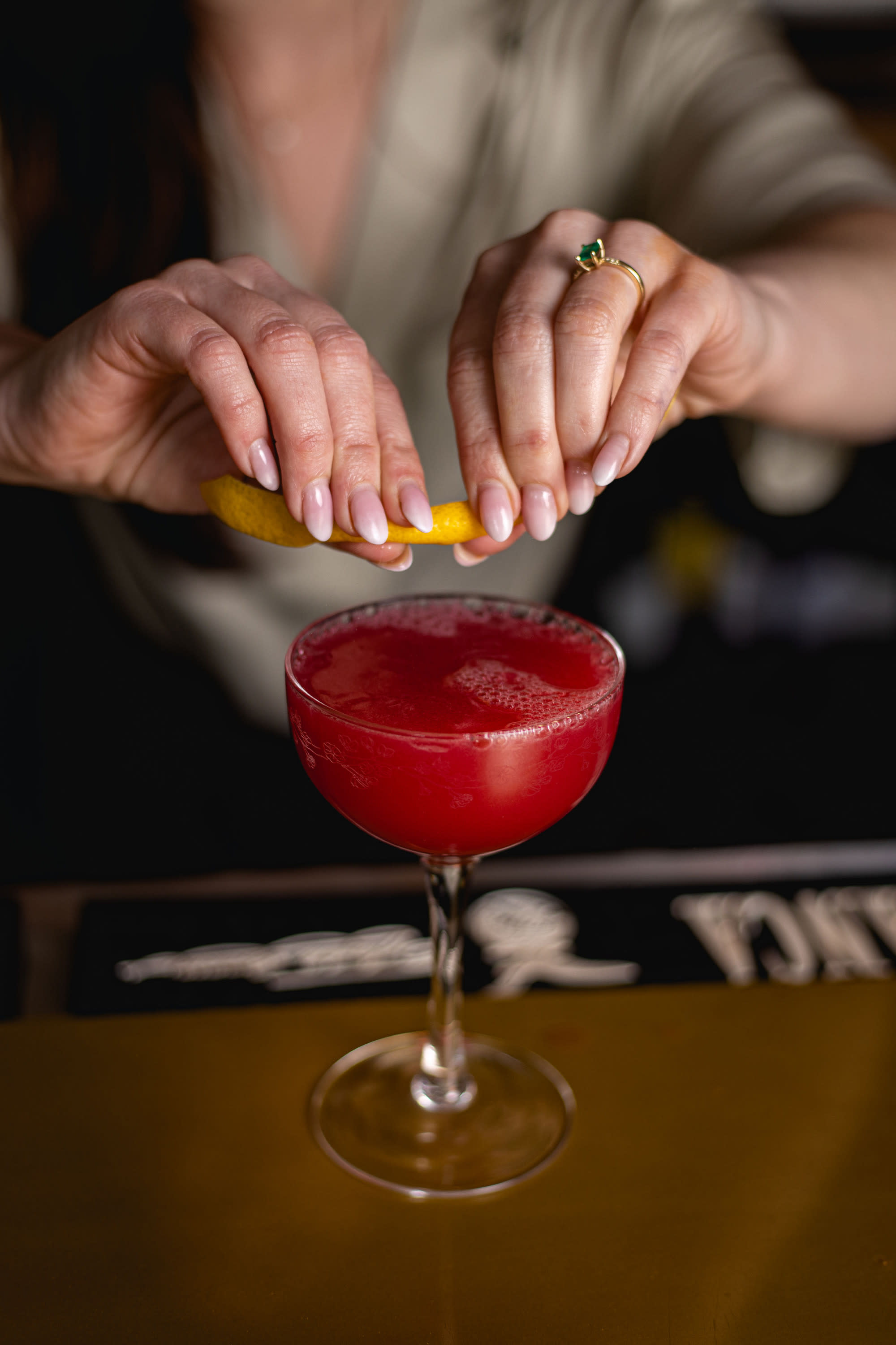 Curling a lemon rind on a cocktail