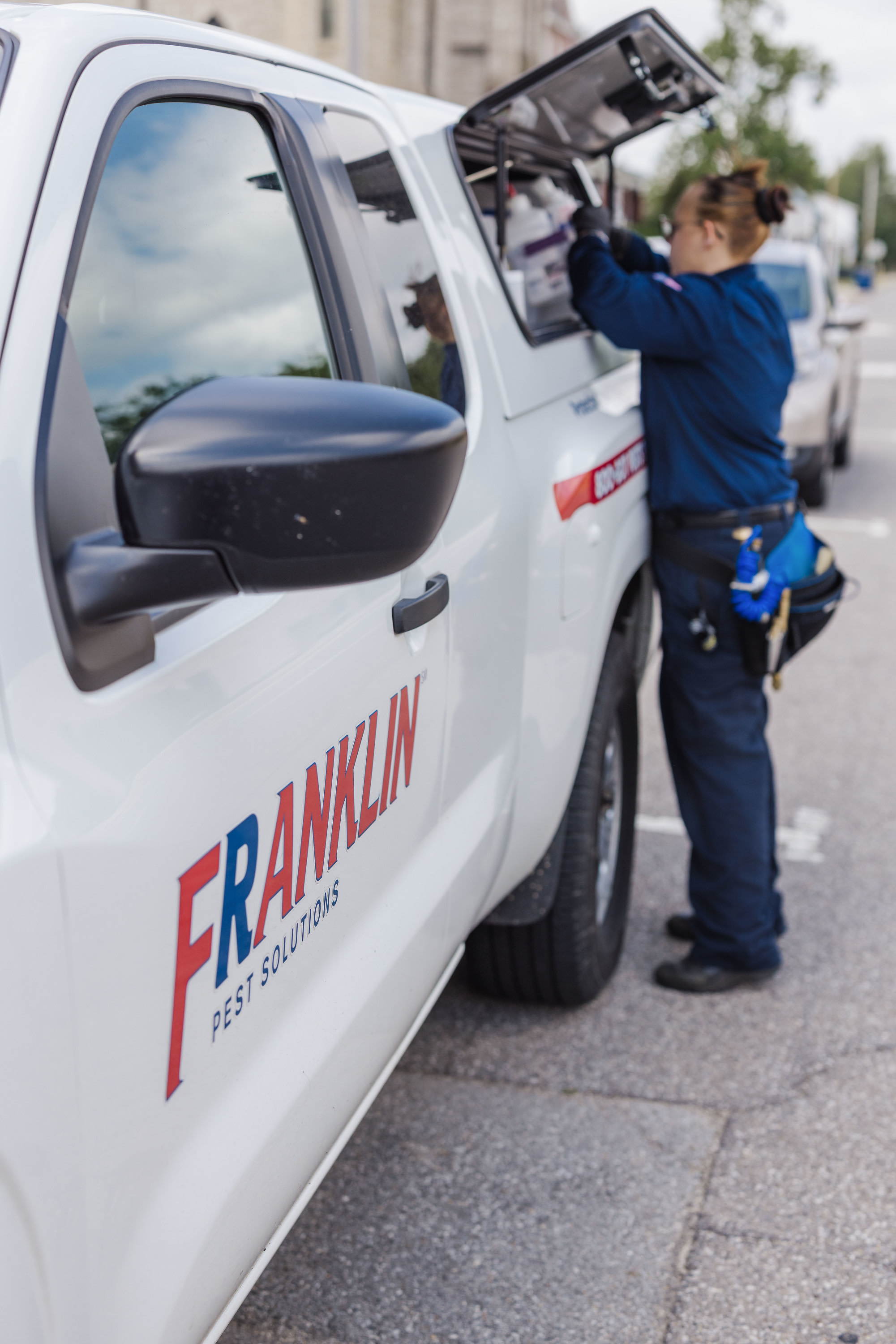 franklin pest solutions technician at her truck