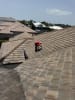 Mighty Fine Roofing technician repairing a tile roof in Naples, FL