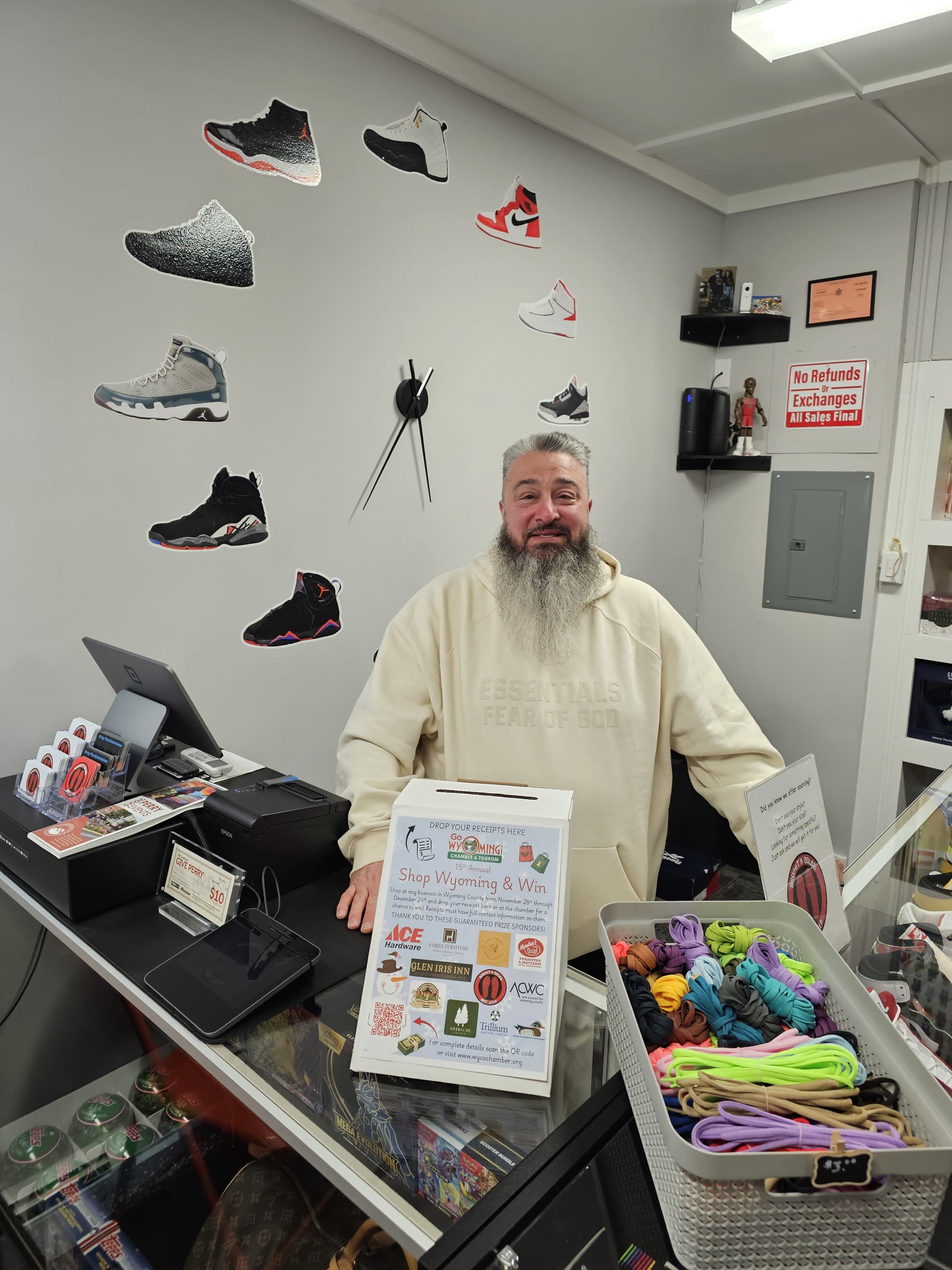 owner standing at counter with shop wyoming and win box