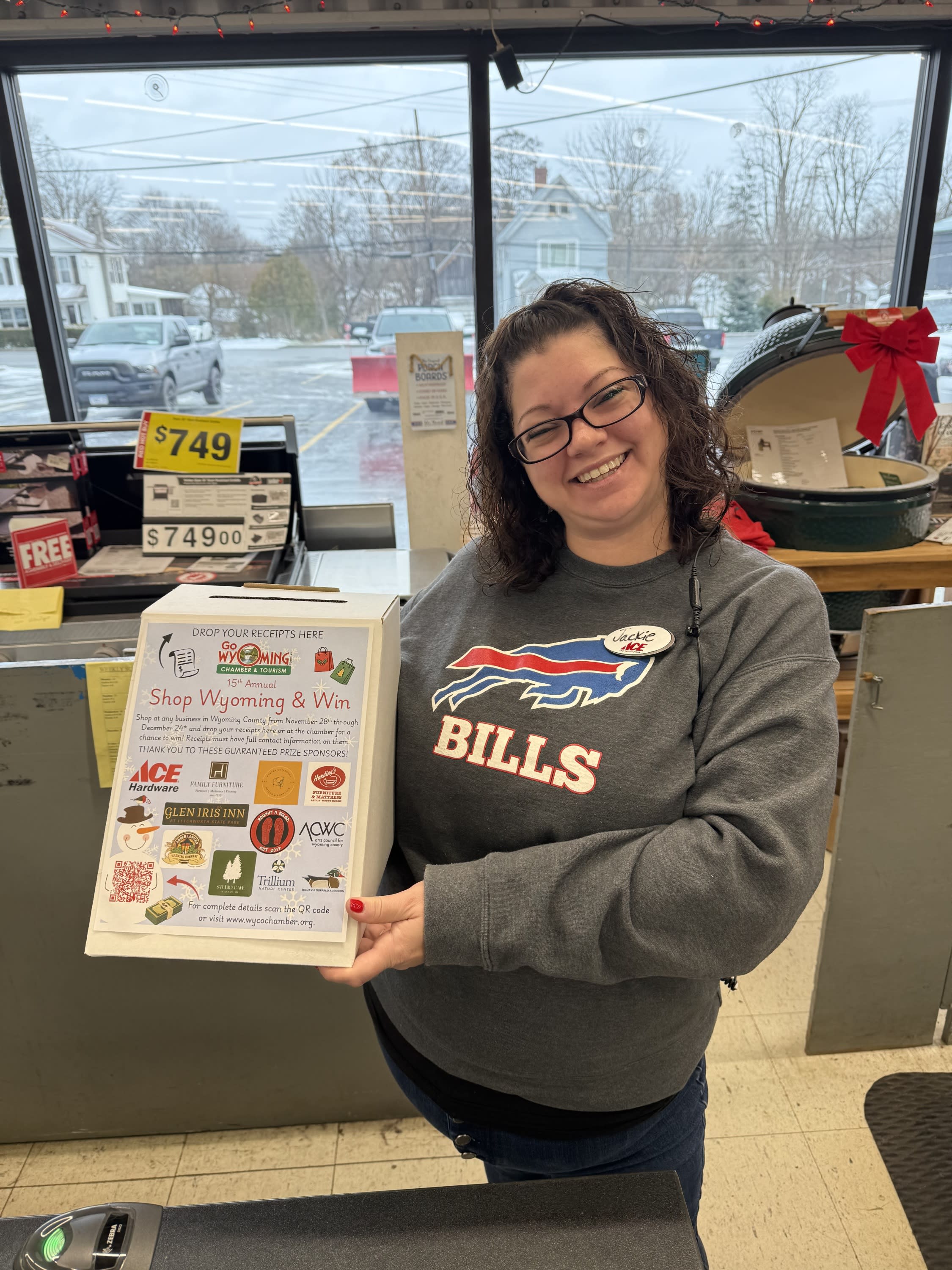 employee holding shop wyoming and win box at the counter