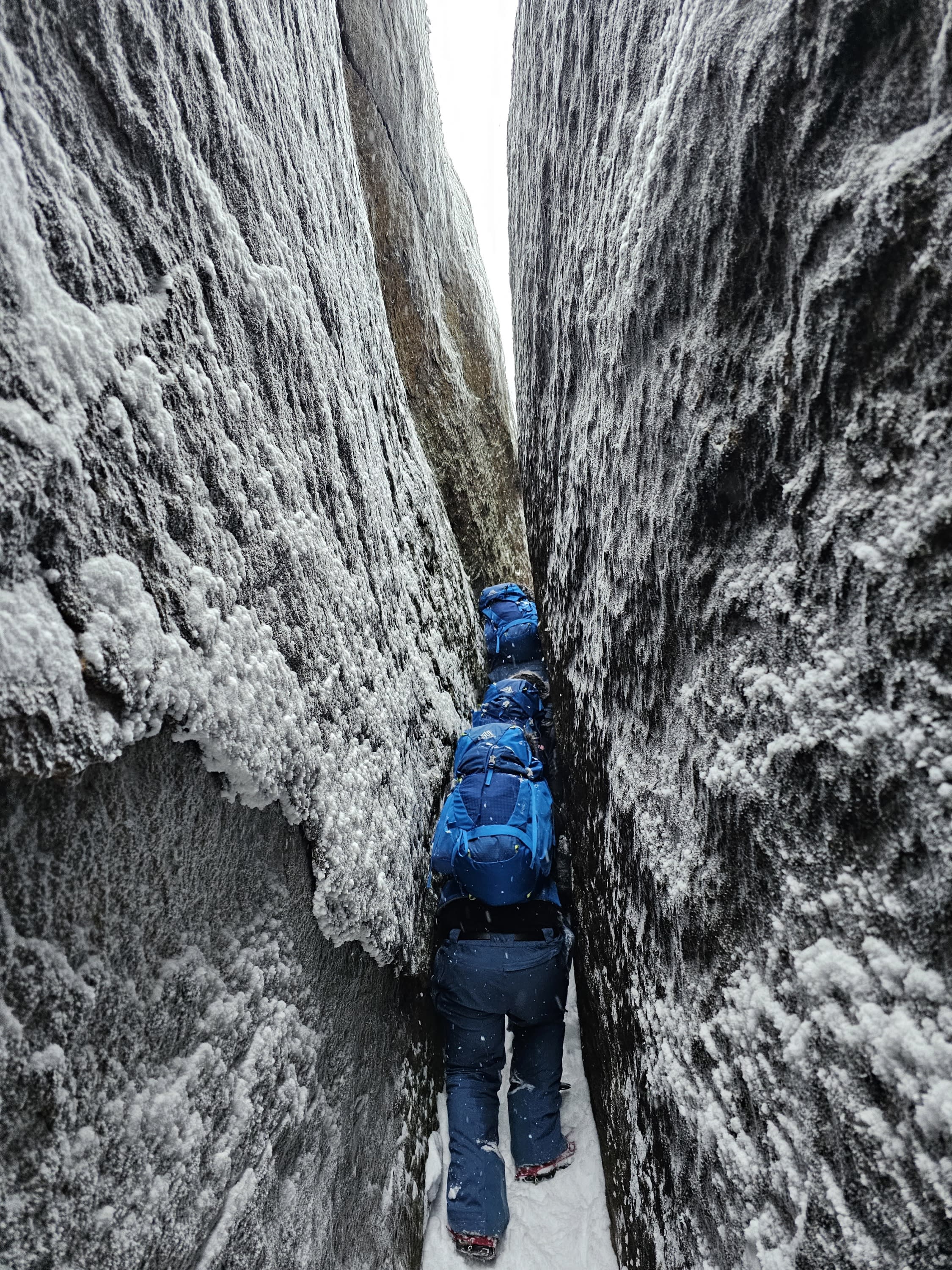 Students navigate a wintery chasm.