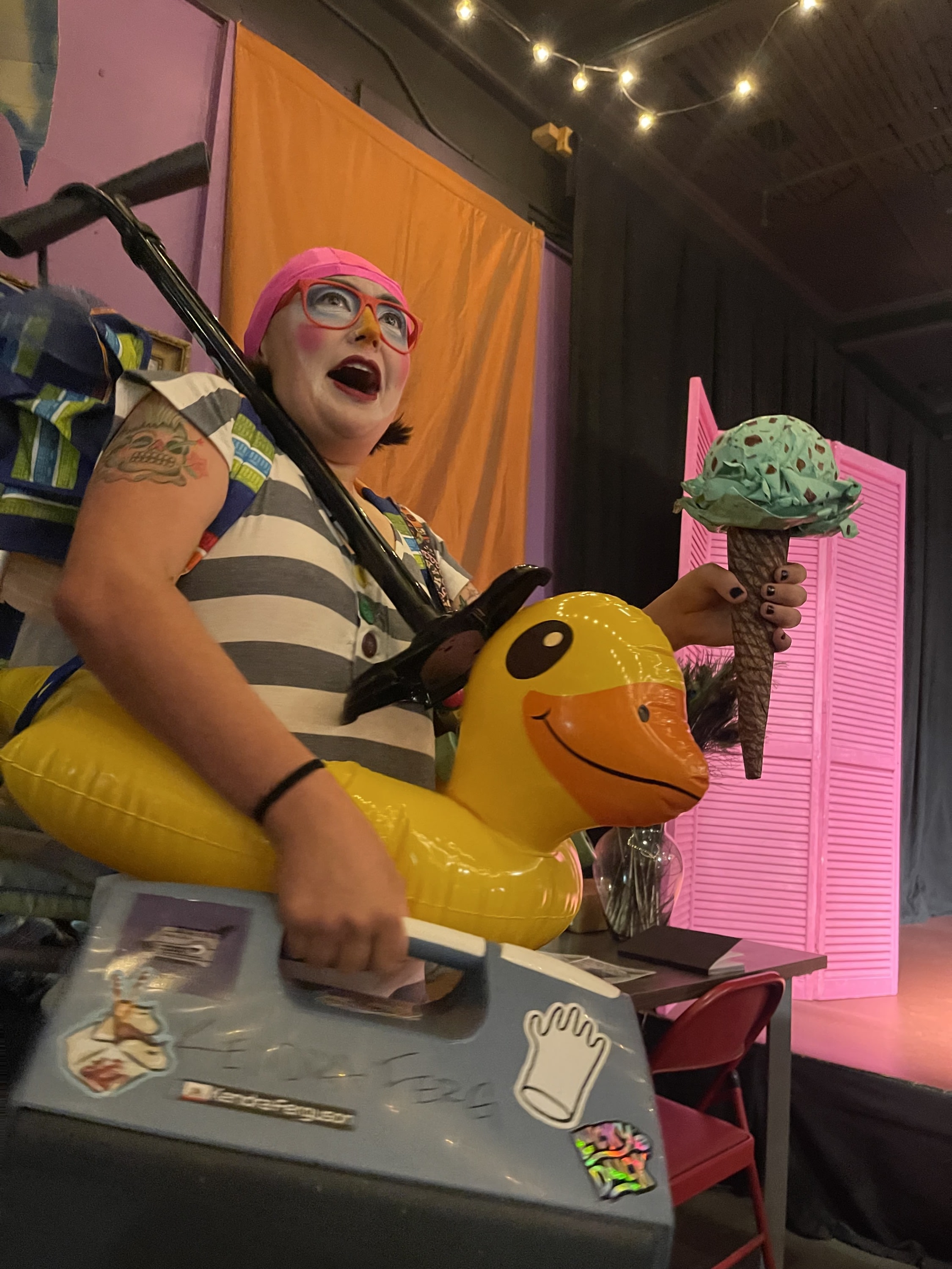 a clown with brightly colored beach gear