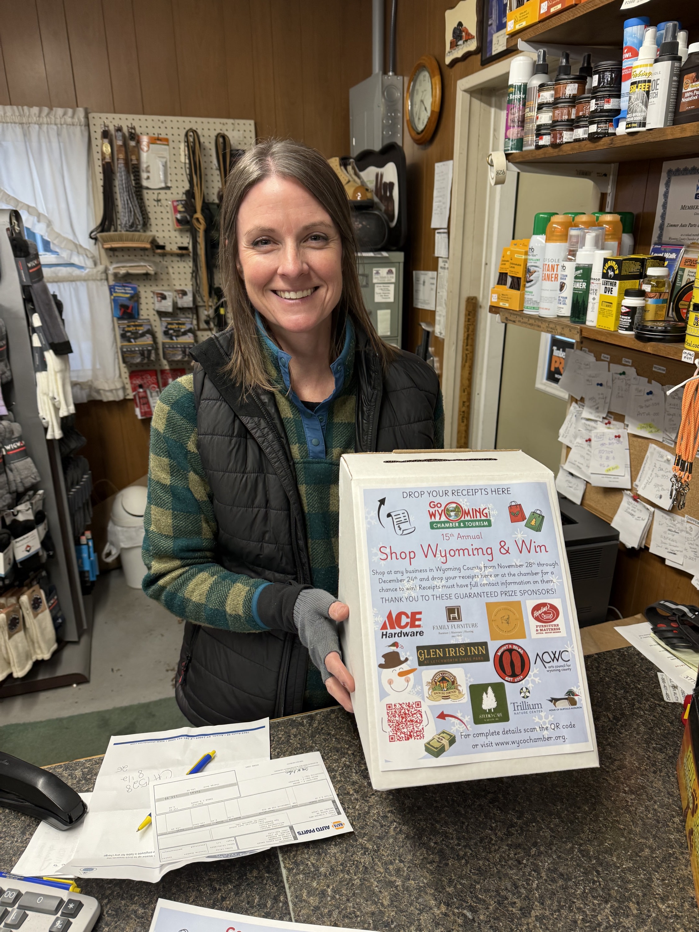 woman holding shop wyoming and win box at zimmer footwear counter