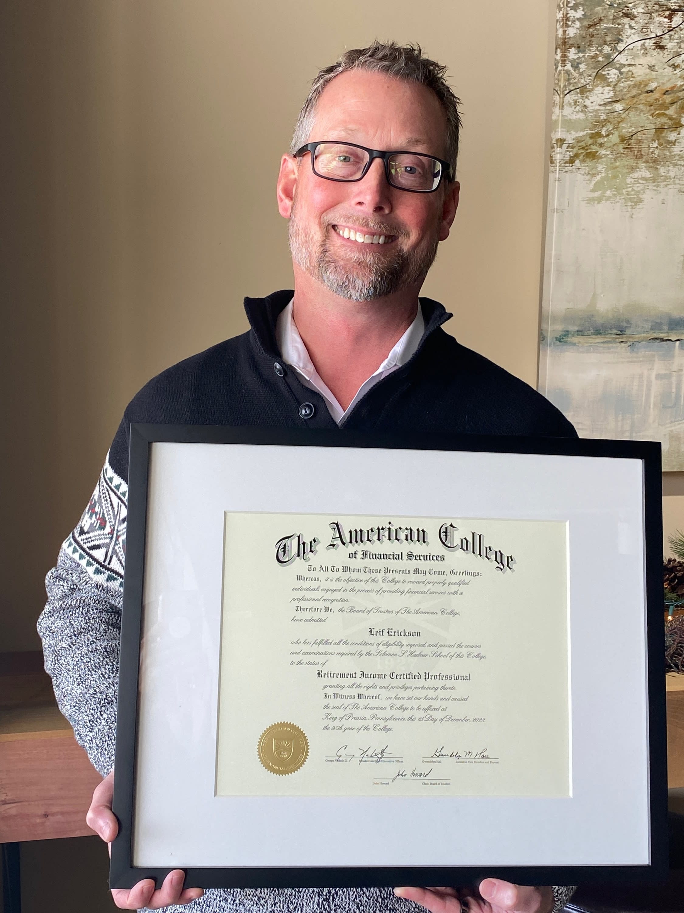 Leif Erickson holding his Retirement Income Certified Professional® certificate