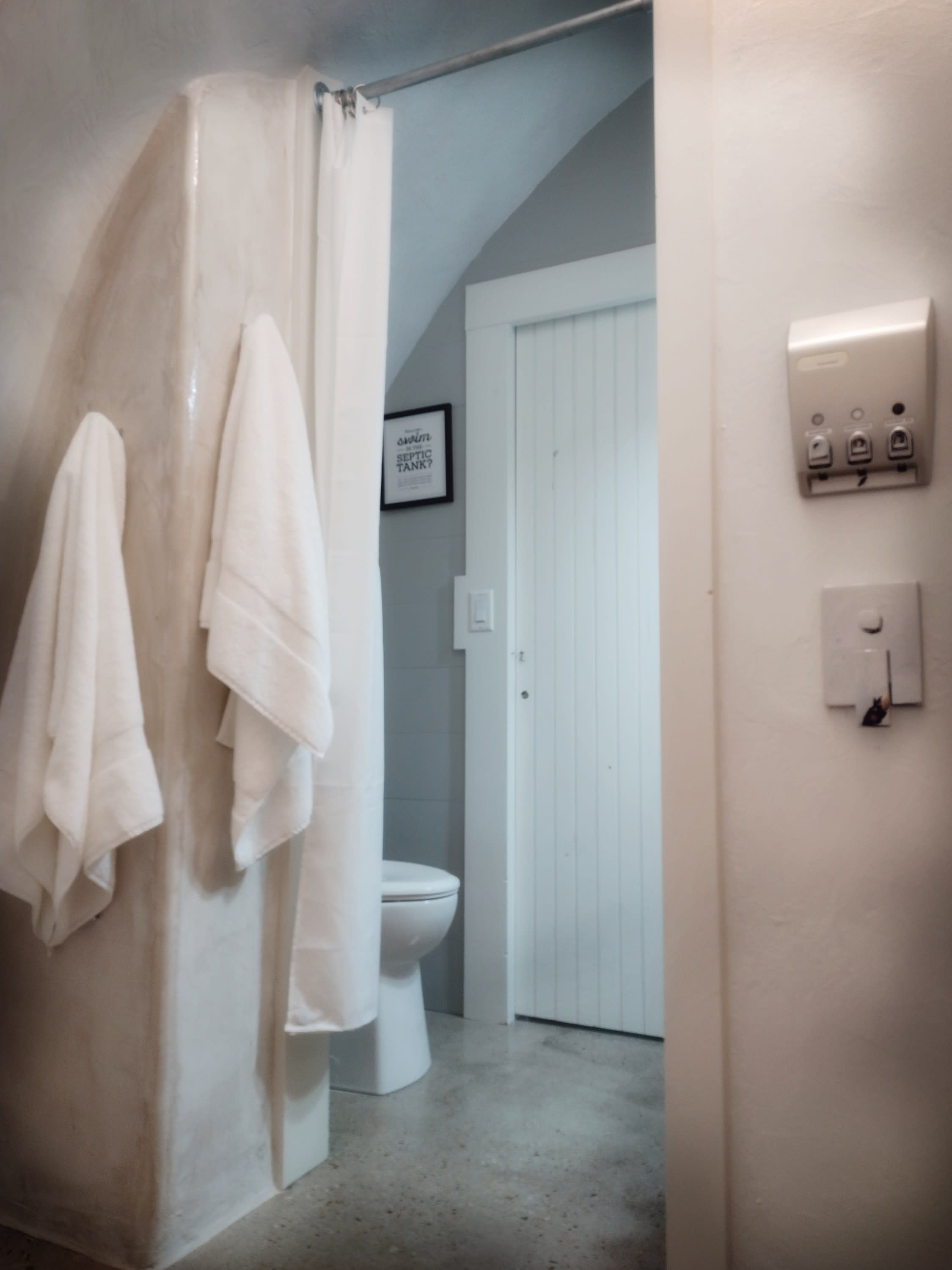 Bathroom has a rainfall showerhead in the walk-in shower.