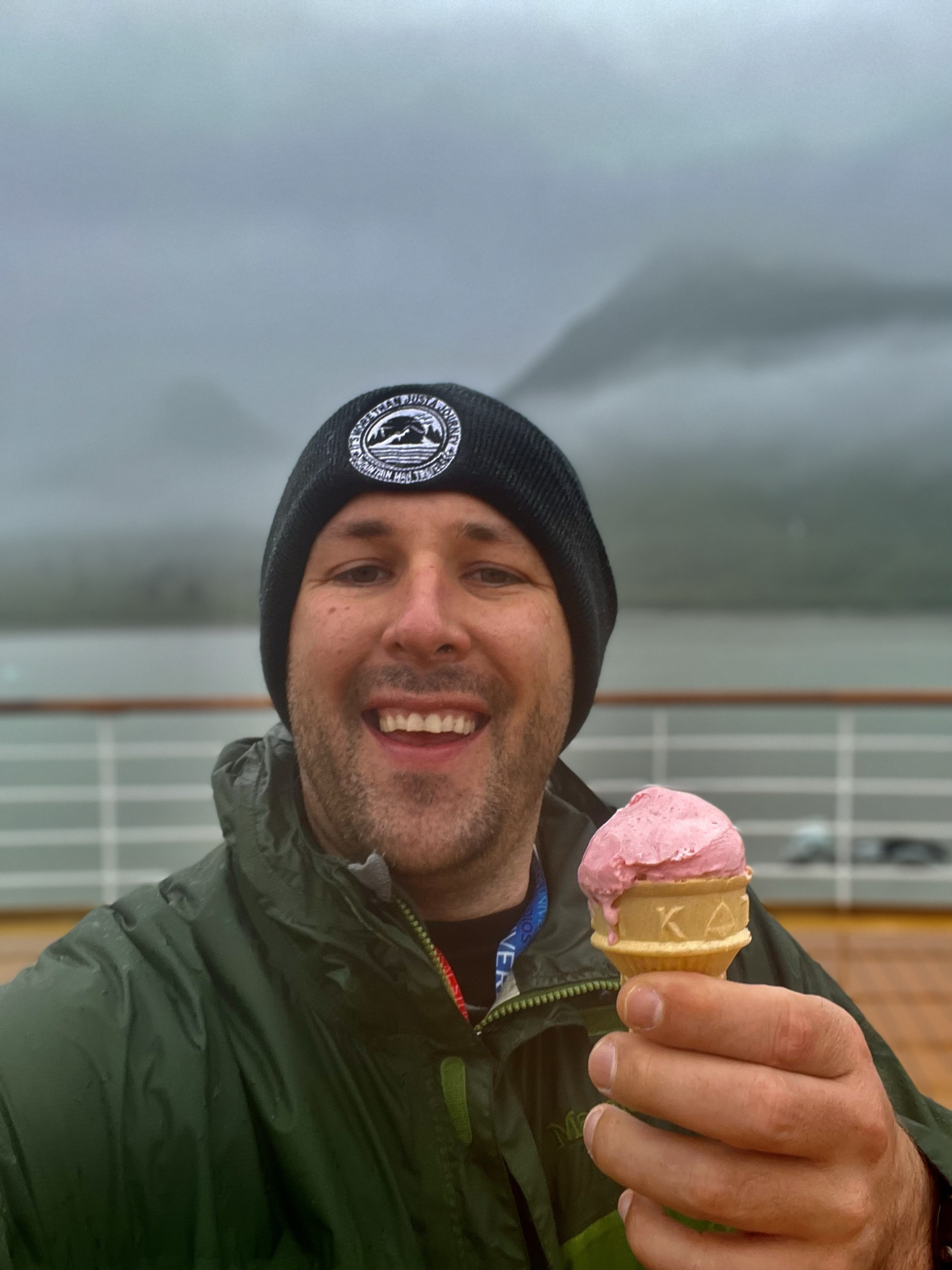 Man with ice cream cone on a cold rainy day in Alaska