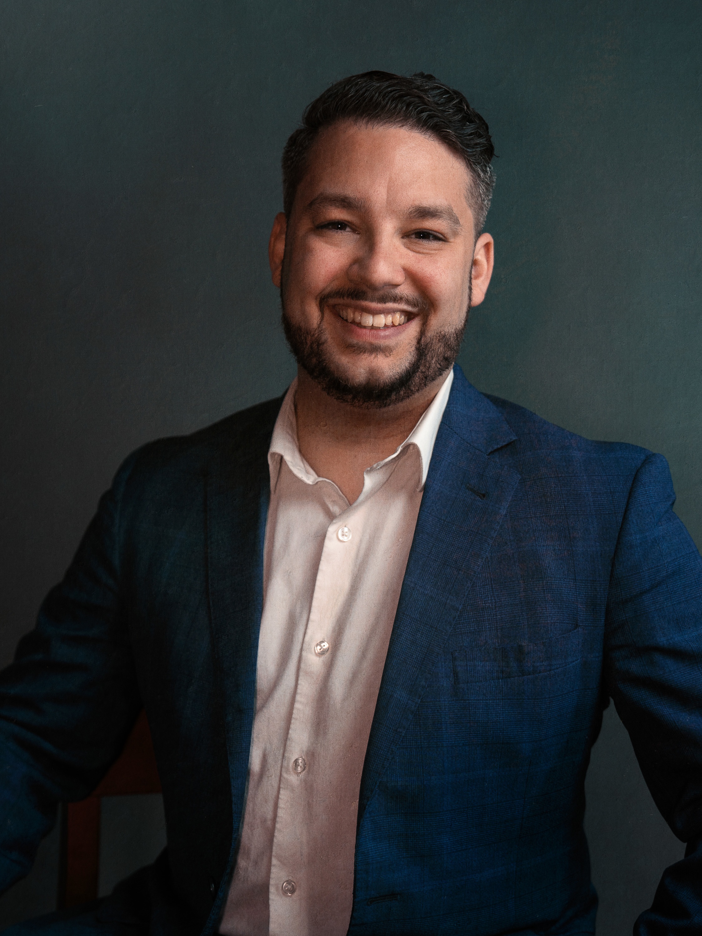 Professional Financial advisor in a blue suit with a professional background.
