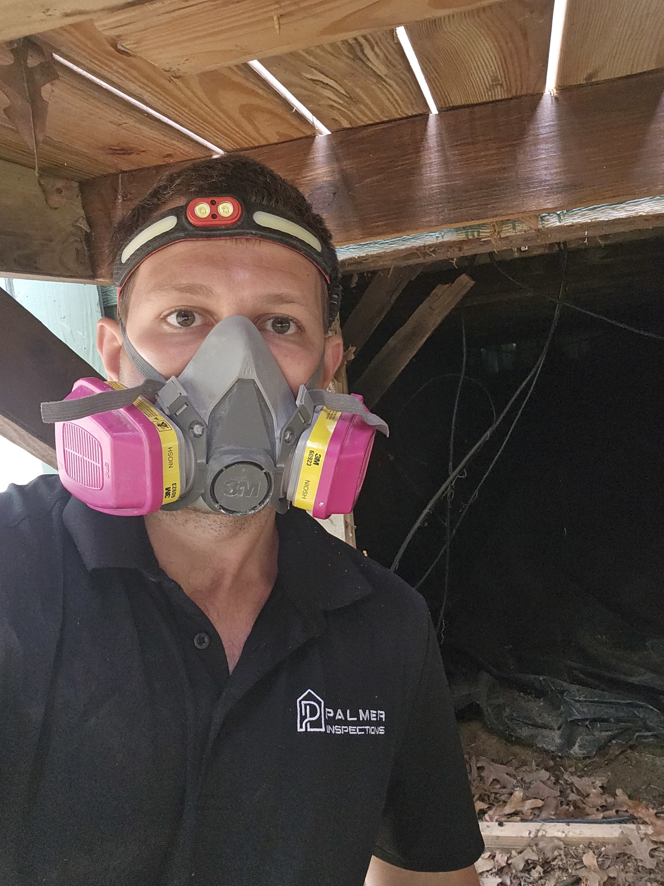 Palmer Inspections home inspector in Longview TX performing crawlspace inspection with safety gear for East Texas properties.