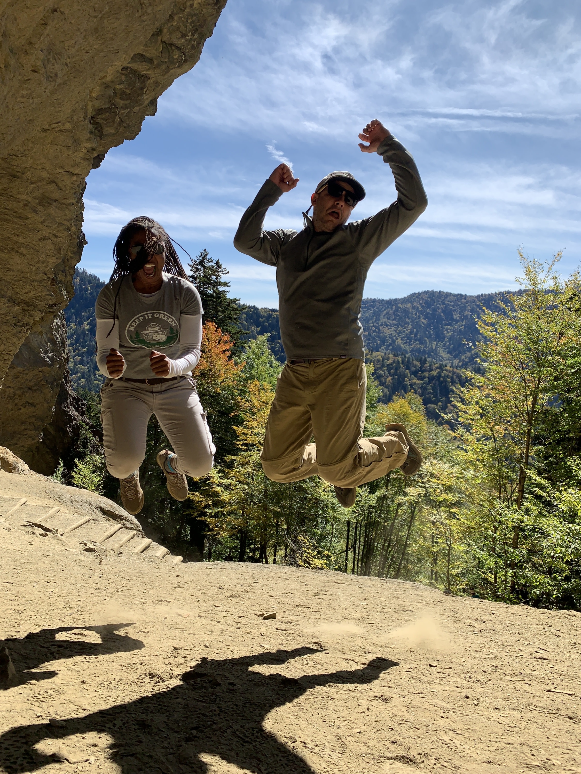 Two people jumping in the air at Alum Cave Bluffs