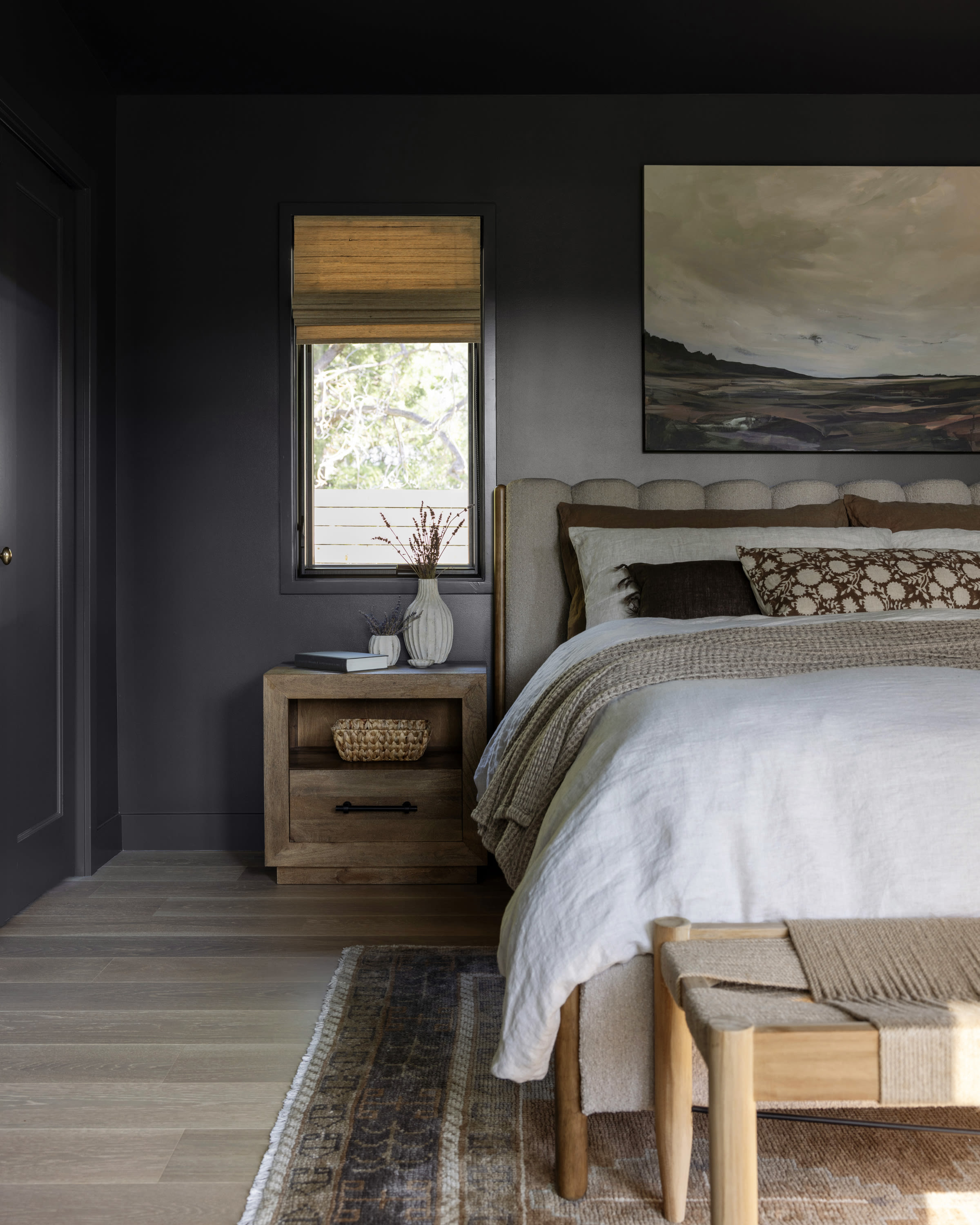 Organic modern primary bedroom with soft neutrals and layered natural textures