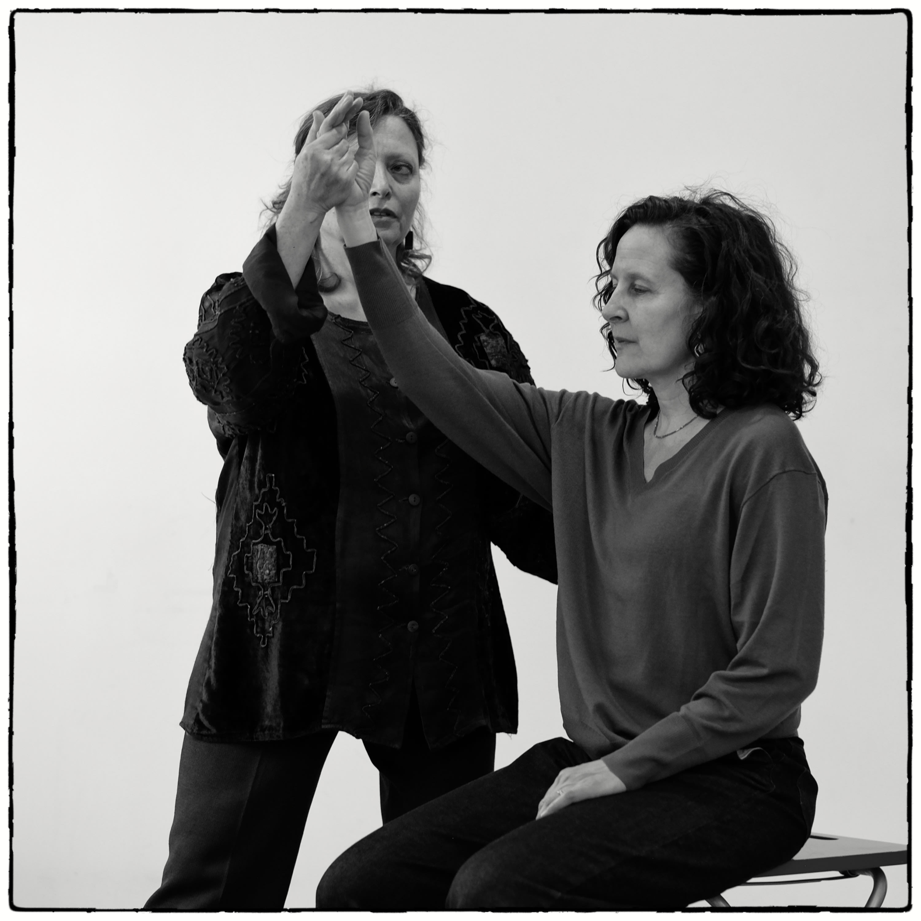 Encouraging raising one's arm without elevating shoulder unnecessarily