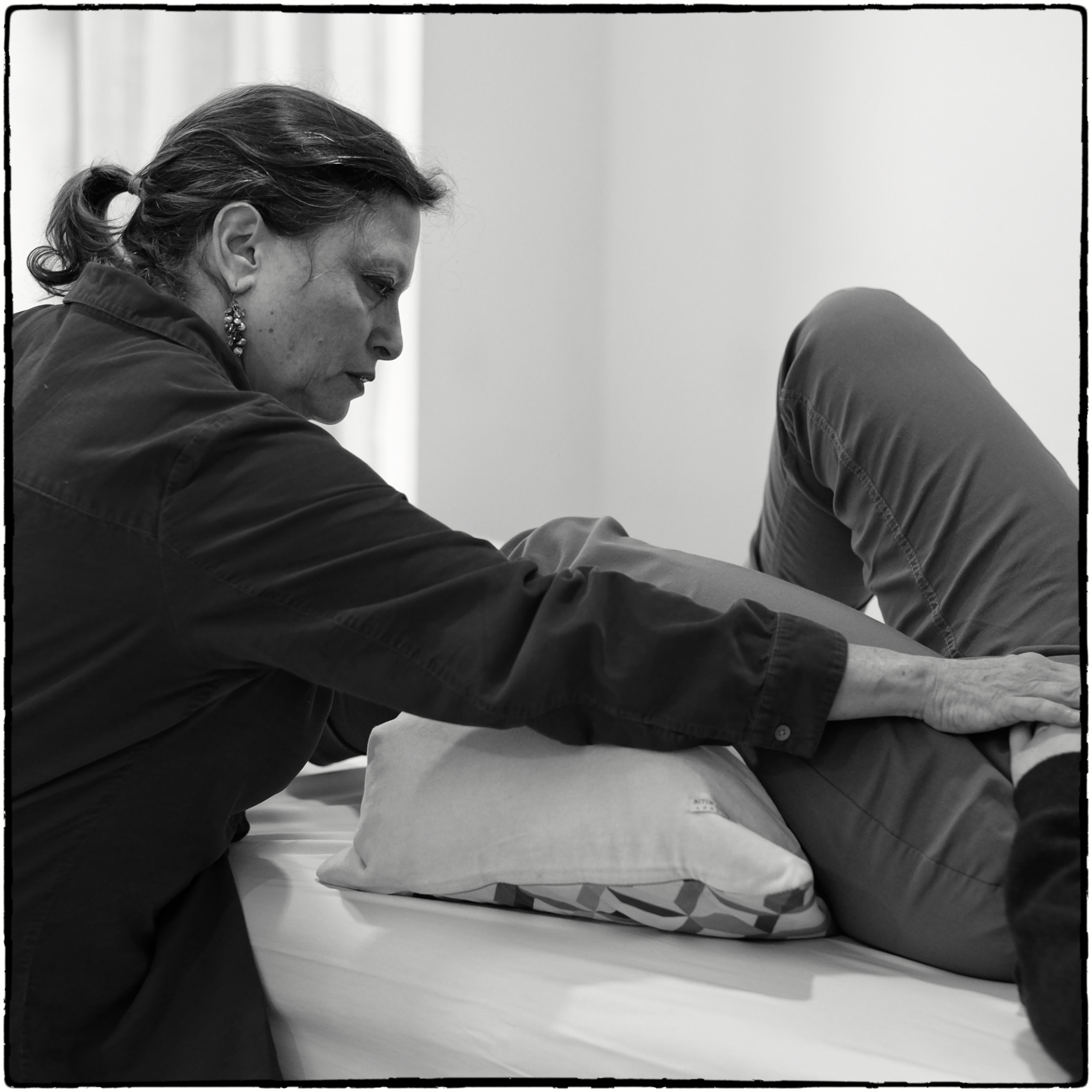 Encouraging student's thigh to release away from their hip joint