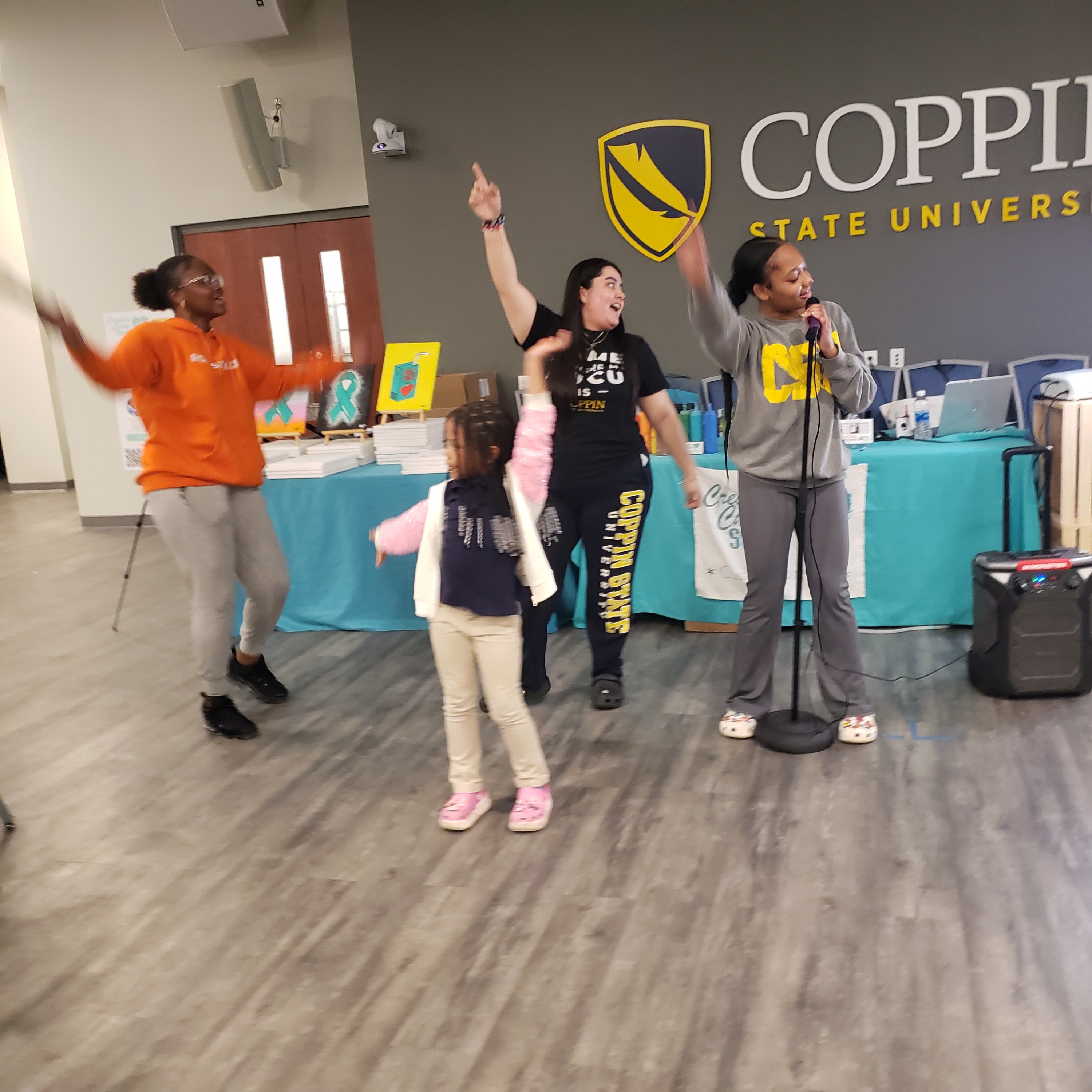 students singing karaoke at a Coppin State University paint event