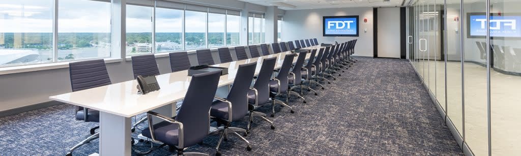 Large conference room with empty table and chairs