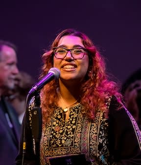 MCC Student Sarah Salmi performing on stage.