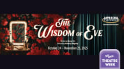 Red Roses cascade over a vanity mirror of a 1940's dressing room station. The Wisdom of Eve in beautiful script writing.