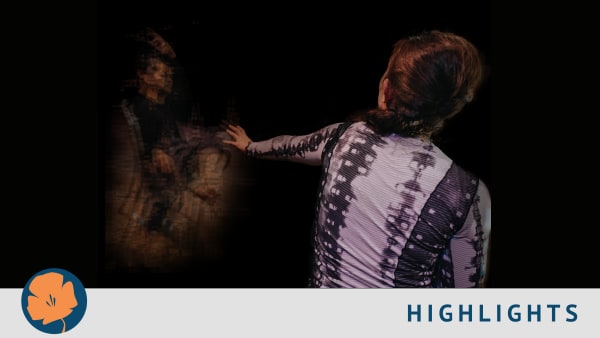 A person faces away from the camera and reaches their left arm towards a distorted outline of a person.