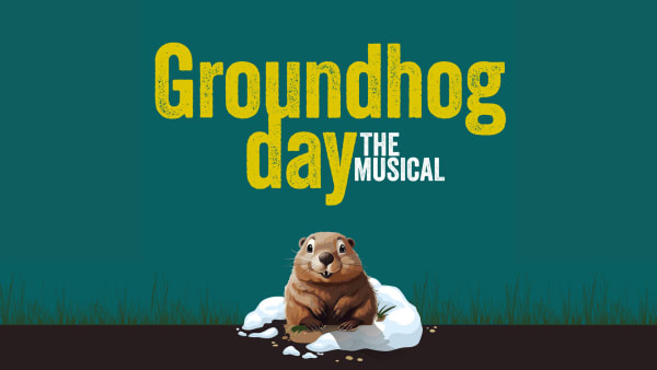 Groundhog popping up from a snowy bank with the words Groundhog day