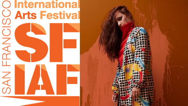 Anneli Kanninen stands in an abstract-patterned outfit against a paint-splattered wall.