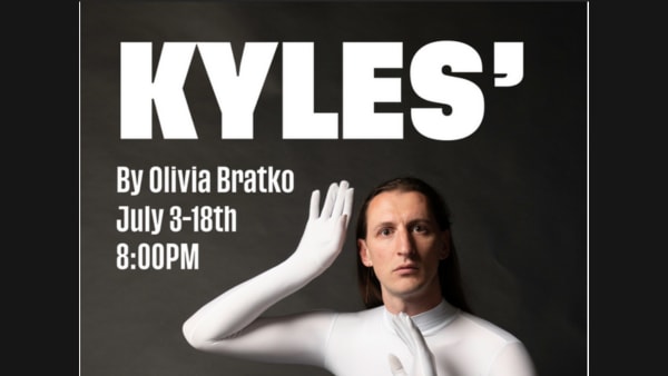 Olivia Bratko gazes at the viewer mysteriously, wearing a white polyester bodysuit.