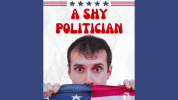 white man with short brown hair and brown eyes hides behind a red, white, and blue american flag. Text: A Shy Politician